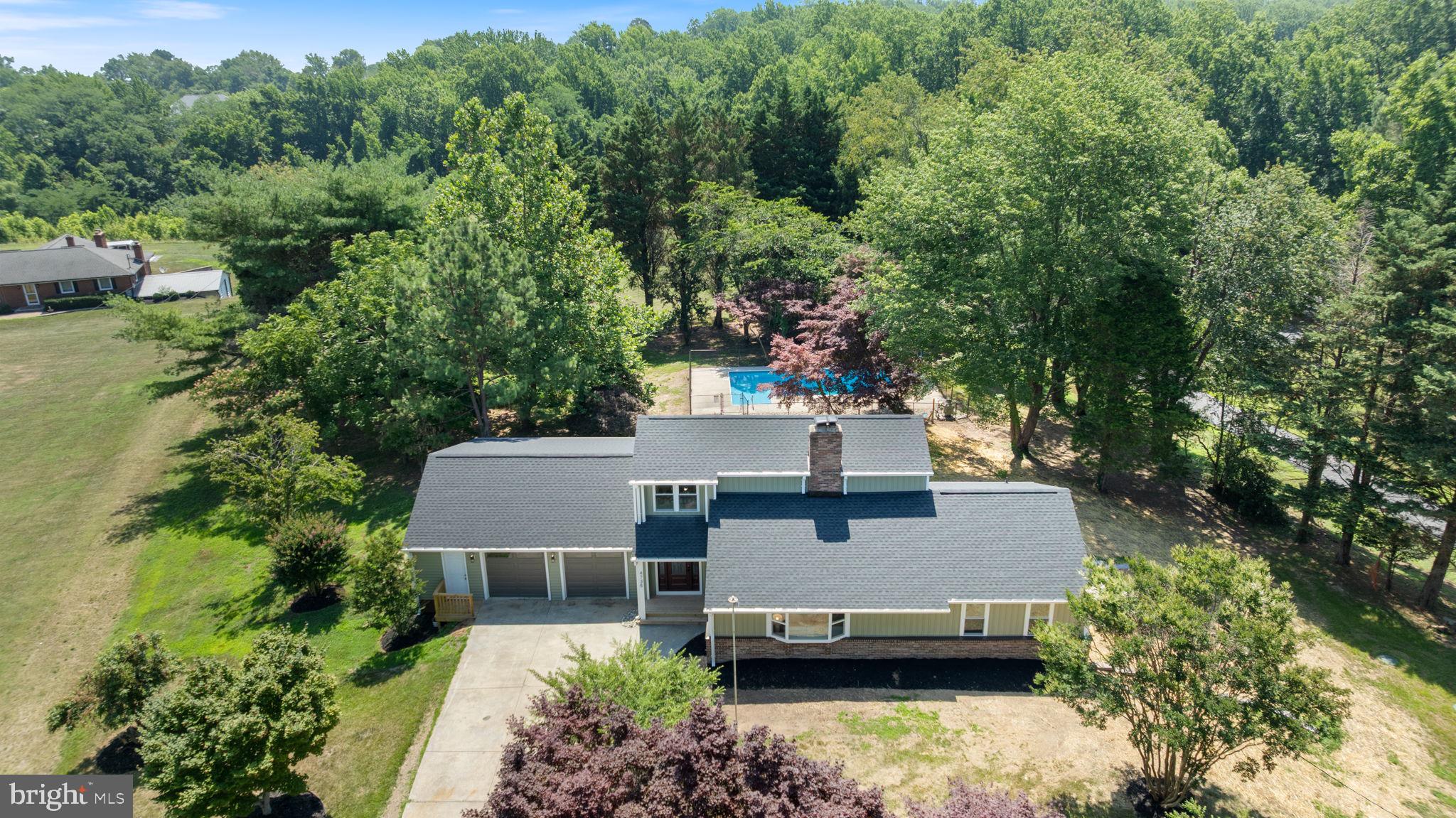 Welcome home to this beautifully renovated property in the heart of Huntingtown, where thoughtful updates, flexible living space, and a fantastic location come together to create a home you will truly enjoy. Situated on a private one acre lot with no HOA, this home offers the perfect blend of comfort, style, and convenience while providing an easy commute to Andrews Air Force Base, Washington DC, Northern Virginia, Annapolis, and the surrounding areas.

From the moment you arrive, you will appreciate the extensive renovations that have transformed this home. Nearly every major feature has been updated including new siding, a new roof, all new windows, dual zoned HVAC systems, luxury vinyl plank flooring, carpet, beautifully renovated bathrooms, and a stunning kitchen that is sure to become the heart of the home. The kitchen features elegant quartzite countertops, butcher block accents, two tone cabinetry, stainless steel appliances, and a layout that overlooks the backyard and sparkling pool, making it easy to stay connected while preparing meals or entertaining guests.

The unique floor plan offers incredible flexibility for a variety of lifestyles. The main level includes three spacious bedrooms while the private upper level serves as a true owner's retreat. This peaceful suite features a beautifully designed bathroom with dual vanities, a large walk in shower with a built in seat, and a sleek glass enclosure, creating the perfect place to relax at the end of the day. During the winter months, you can even enjoy seasonal views of the Chesapeake Bay from the upper level.

Natural light fills every room thanks to the abundance of new windows, creating bright and welcoming spaces throughout the home. The cozy family room with its wood burning fireplace is the perfect gathering place on cool evenings, while ceiling fans throughout the bedrooms and living areas add comfort year round.

The finished walkout basement opens up even more possibilities. Complete with a fifth bedroom, full bathroom, wet bar, and its own private entrance, this space could easily become an in law suite, guest quarters, private living area, or even provide rental income to help offset your mortgage.

Step outside and enjoy everything this property has to offer. The spacious deck is ready for summer barbecues, outdoor dining, and relaxing evenings overlooking the pool. The pool has been well maintained with a new liner and new pump, making it ready for years of enjoyment. The backyard provides plenty of room for play, gardening, pets, or simply enjoying the peaceful surroundings.

Car enthusiasts, hobbyists, and anyone needing extra storage will love the oversized attached garage. With room for two vehicles, a generous workshop area, and a separate utility garage for lawn equipment with convenient access to the backyard, this space is truly a rare find.

If you have been searching for a move in ready home with modern updates, flexible living space, an incredible outdoor setting, and a sought after Huntingtown location, this property deserves a place at the top of your list. Homes with this combination of quality, space, and convenience do not come along often. Schedule your private showing today before someone else calls it home. Owners are licensed Realtors in Maryland and Virginia.