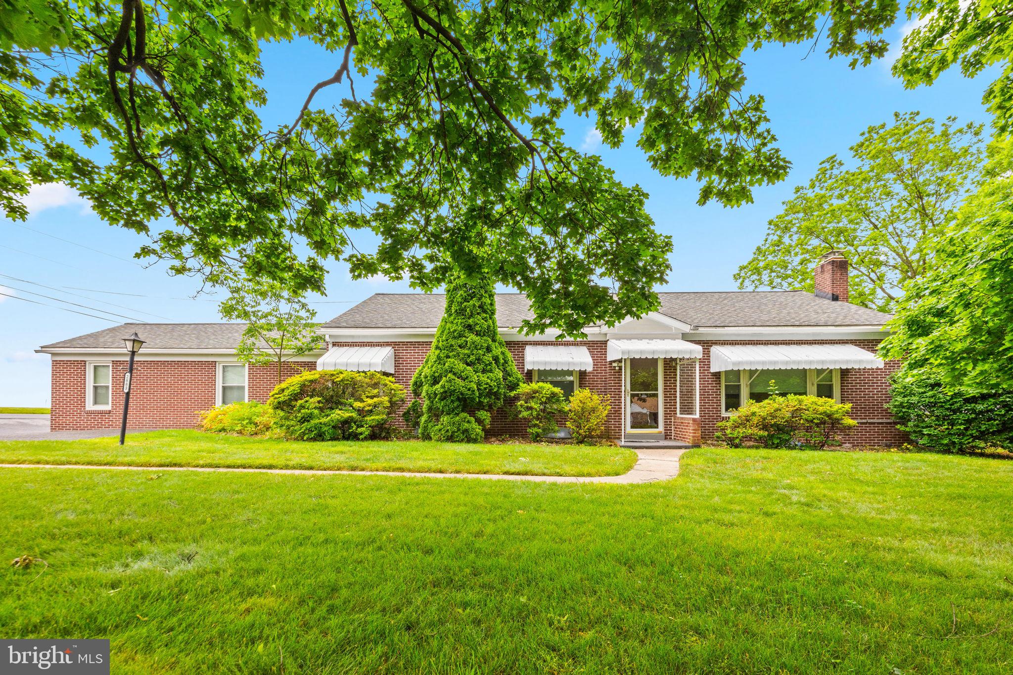 Opportunities like this are few and far between! This exceptionally well-built brick home has been meticulously maintained and sits on nearly an acre of land—with no HOA restrictions! Beautiful hardwood floors flow throughout much of the home, while the spacious family room with a cozy fireplace creates the ideal gathering space. The renovated primary suite is a true retreat, featuring a luxurious bath with a soaking tub, separate stand-up shower, and heated floors. Convenient main-level laundry adds everyday practicality, and the conditioned sunroom provides incredible versatility as a home office, den, playroom, or even a potential fourth bedroom. Outside, you'll find a pressed concrete patio perfect for grilling, entertaining, or simply relaxing while overlooking the fenced yard that is ideal for pets or young children. The unfinished basement has already been fully waterproofed with a French drain system, providing a clean, dry canvas ready to be finished to your exact specifications and significantly expand your living space. Car enthusiasts, hobbyists, contractors, and RV owners will be especially impressed by the unmatched storage and workspace options, including an attached two-car garage, carport, RV parking area, and an additional oversized two-car detached brick garage. Recent improvements include a replacement architectural shingle roof and gutter guards for added peace of mind. Located just minutes from the charming town of Manchester and its local shops and restaurants, while also offering easy access to Westminster, Hampstead, and all the amenities they provide, this is an incredible opportunity to own a quality-built home with room to grow, space to work, and endless possibilities.