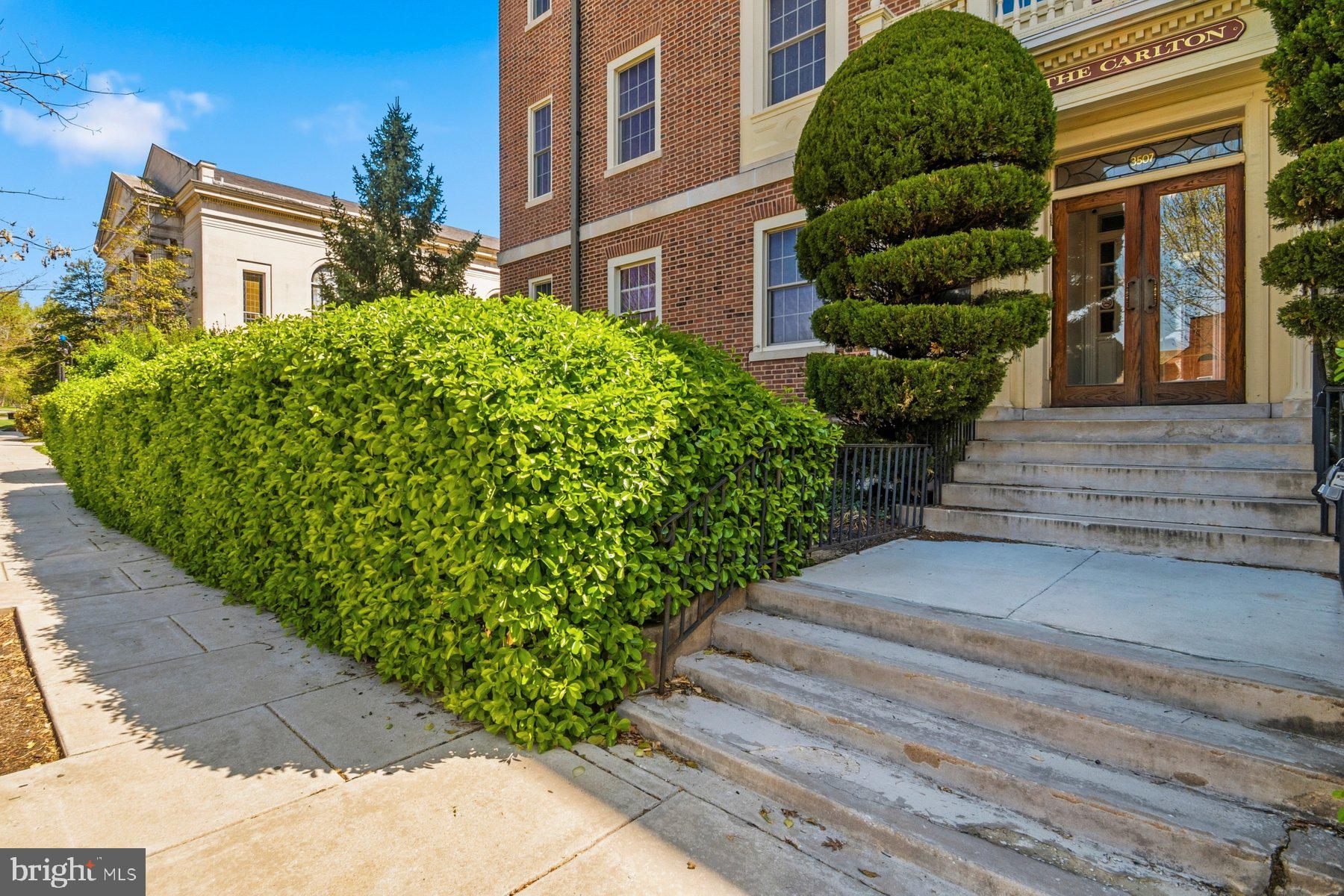 Perched on the top floor of The Carlton, this 3 bedroom residence blends timeless architectural character with modern convenience in one of Baltimore’s most walkable locations—just steps from Johns Hopkins University.
Natural light pours into the approximately 1,100 square feet of living space, highlighting soaring ceilings, rich oak floors. The spacious living area is anchored by an ornamental fireplace, adding warmth and charm, while replacement windows enhance comfort and efficiency throughout. The kitchen retains its original butler’s pantry—an architectural detail that adds both function and historic appeal—while incorporating modern touches including an in-unit washer and dryer for everyday ease. Step outside onto the impressive 32-foot private balcony, offering a rare outdoor retreat with elevated views and abundant sunlight.
Additional features include central air conditioning and a deeded parking space (#7) located behind the building with convenient access off University Parkway, just east of North Charles Street. The monthly condo fee includes heat and water, and residents also enjoy extra storage in the lower level along with a secondary laundry facility.