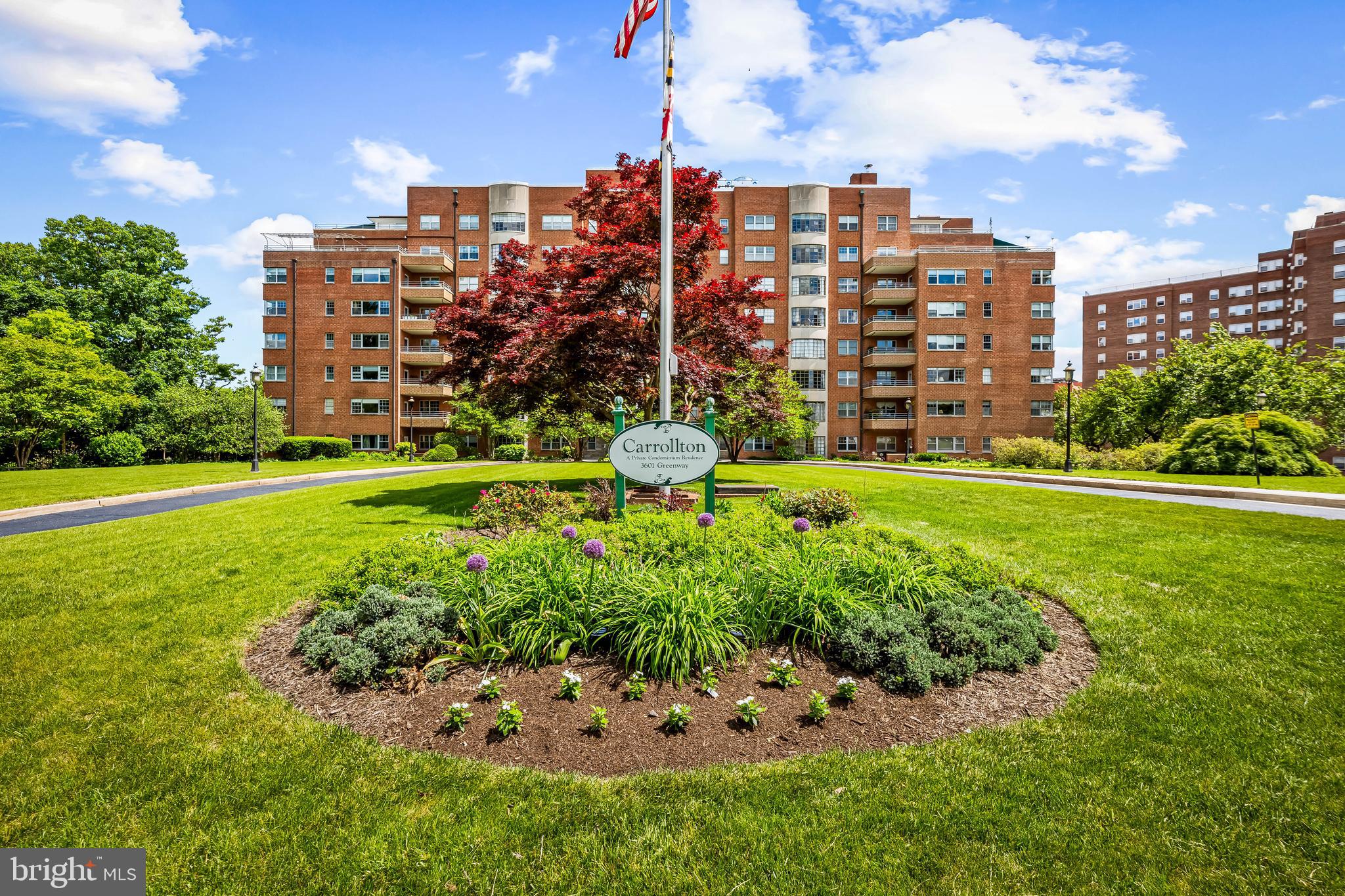 Welcome to the Carrollton! This stately brick condominium is beautifully cited on a lush radiant level lot which fronts on the Guilford Gateway Park, a Park given in honor of visionary developer Edward Bouton. Equally inviting is the elegant lobby, with floor to ceiling windows. Take a short ride on the elevator to unit 705.  Warm and inviting from the minute you walk in the door – updated kitchen, parquet wood floors, built-in bookshelves and enchanting balcony with new terra-cotta floors, ideal for morning coffee, Wordle, and stargazing. Large living room can accommodate so much. Intimate dining room, two spacious bedrooms with builtins and large size closets and two lovely bathrooms with classic black-and-white basket weave flooring. Deeded garage covered parking. Full service building with helpful knowledgeable staff. Minutes from the excitement of Charles Village - eateries, breweries, coffee shops, and more. Easy to call home and enjoy!