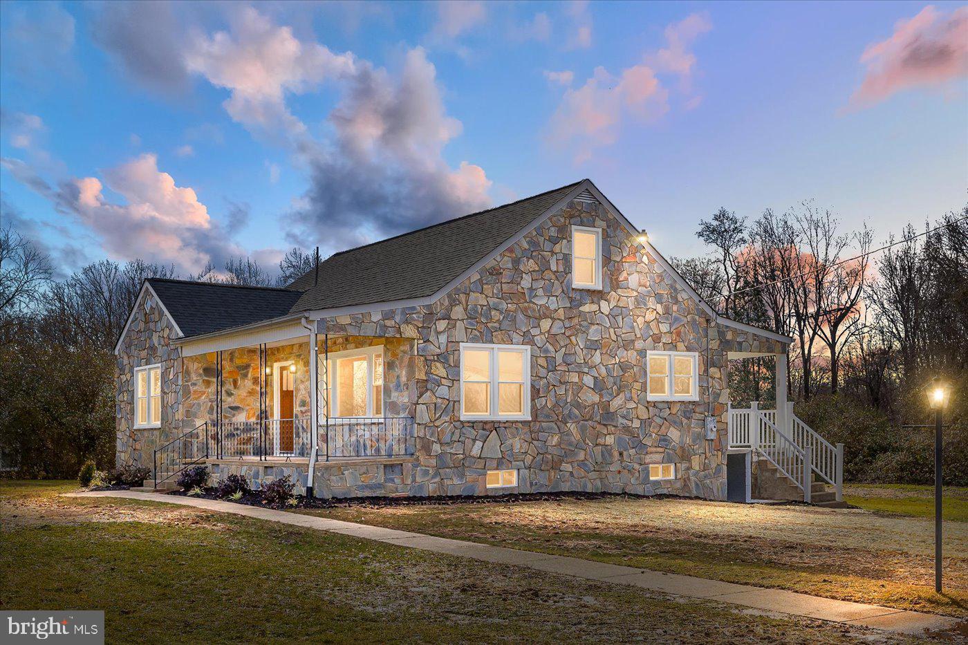 Completely updated 1950s Cape Cod - modern living merges with vintage charm! Beautiful stone exterior with front and back porches that overlook the home's large 1 acre lot. Inside you'll love details like the original solid hardwood floors and the oversized trim/baseboard. And all new features include: new roof with architectural shingles; new windows; new well pump; new HVAC including ductwork; all new kitchen with new soft-close cabinetry, new granite counters, new stainless steel appliances, new sink, new faucet, and new LVP flooring; new carpet on the upper level; and new full bath with new flooring, new tub, new tile surround, new vanity, new toilet, and new faucet. Find also new gravel in the circular driveway, updated plumbing, and updated electrical. Full unfinished basement offers plenty of room for storage. Filled with warmth and coziness, you will fall in love with this solidly built home as soon as you enter! Agent related to Owner. OFFERS DUE BY 8PM ON SUNDAY 01/14.