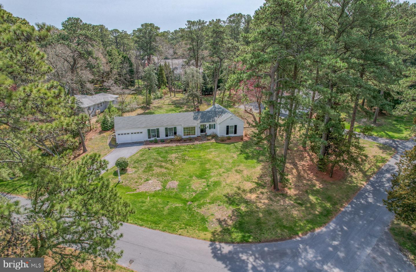 Situated on over a half acre in the highly sought after Henlopen Acres, 7 Broad Hollow is a charming rancher in a prime location. Just two blocks from the private beach, this corner lot includes beautiful mature trees creating a serene setting. Step inside this recently updated rancher to find hardwood floors, freshly painted paneled walls, exposed beams, and a brick surround wood burning fireplace. Additional features include 4 bedrooms, 2 full baths, an updated kitchen with granite countertops and stainless steel appliances, wet bar, and a spacious screened porch. Enjoy walking to all the restaurants and shops that downtown Rehoboth has to offer, the Henlopen Acres Beach Club, marina and Rehoboth Art League.
