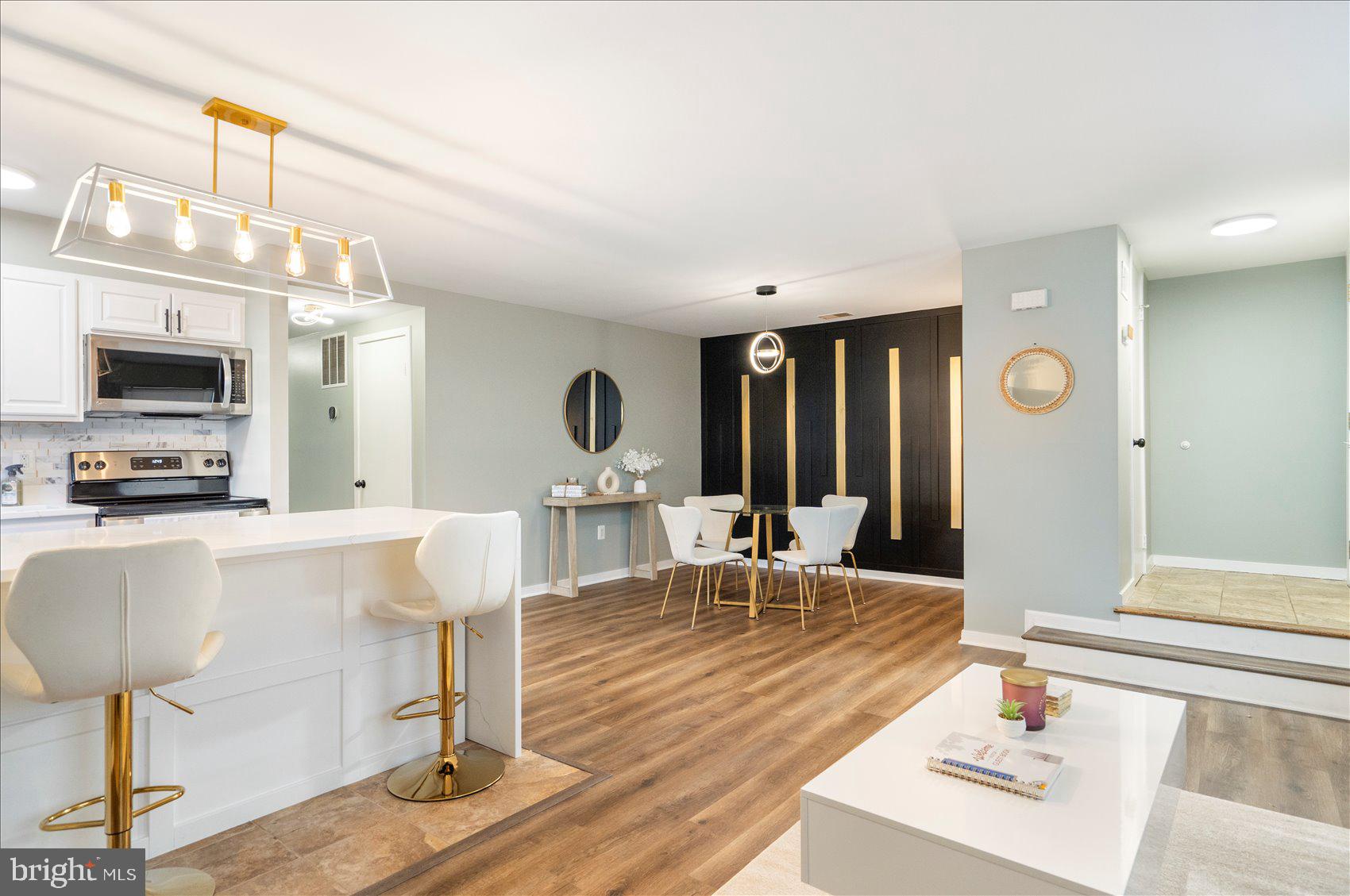 Welcome to this stunning renovated condo in Baltimore’s sought-after Otterbein neighborhood.  Enjoy the best of downtown living in the beautifully renovated ground-level 2 bed, 2 bath end unit with a bright and open floor plan. The living room, dining area and hallway all feature luxury vinyl plank flooring and clear sight lines that create a warm, inviting flow. A cozy wood-burning fireplace adds charm to the spacious living room. The brand new gourmet kitchen is a showstopper- completely renovated with sleek s/s appliances, quartz countertops, tile flooring, and a gorgeous waterfall island. The dining room features a designer black and gold accent wall, bringing modern, stylish touch to the home. Both bedrooms are generously sized with large windows that fill the space with natural light, they also have vinyl plank flooring, and floating console tables that give it that modern feel. Both bathrooms have been  remodeled with a black and white contemporary theme.  Assigned, gated parking conveys—rare and convenient for city living. Unbeatable location just a short walk to the Inner Harbor, MARC train, UMD, Downtown, Federal Hill, M&T Bank Stadium, Camden Yards, all major highways and countless shops and restaurants. Enjoy low‑maintenance living in the heart of Baltimore with everything you love right outside your door. Seller is a licensed realtor. Seller is willing to sell furnishings separately if desired. Hurry this one won't last long.