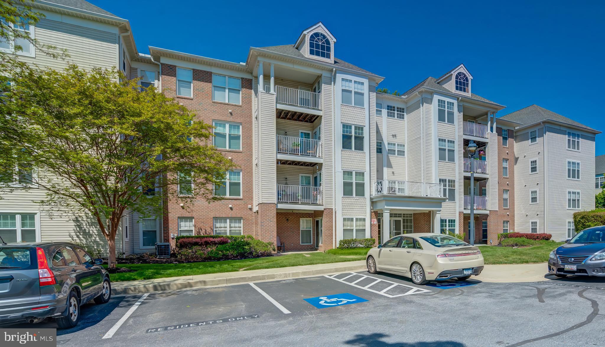 Welcome to this beautifully updated 3rd-floor condo in the desirable Beckett Green community of Owings Mills! This spacious 2-bedroom, 2 full bath home offers an open floor plan with approximately 1,800+ square feet of living space, filled with natural light throughout. A versatile den with French doors provides the perfect space for a potential third bedroom, home office, or exercise room.
The large living room features custom mirrors, while the dining area is highlighted by a stylish chandelier. The spacious primary suite includes a private en-suite bath with a soaking tub, walk-in shower, and a generous walk-in closet. A convenient utility room with washer and dryer offers additional storage space. The eat-in kitchen is equipped with granite countertops, ample cabinetry, stainless steel appliances, a gas range, and a newly installed garbage disposal. Enjoy your own private balcony with scenic views—perfect for relaxing outdoors. Recent updates include a new HVAC system, water heater, washer and dryer, refrigerator with ice maker, and stainless steel gas range. Additional upgrades include luxury laminate plank flooring in the kitchen and utility room, wood flooring in the den, dining room, and hallway, new wall-to-wall carpeting, fresh paint throughout, and custom blinds. This secure, gated community offers elevator access, a welcoming lobby, indoor mailbox area, and ample parking. Condo fees include snow removal, grounds maintenance, and common area upkeep. Conveniently located near Foundry Row, Mills Station, shopping, dining, and major commuter routes. Don’t miss this move-in ready home in a prime location!