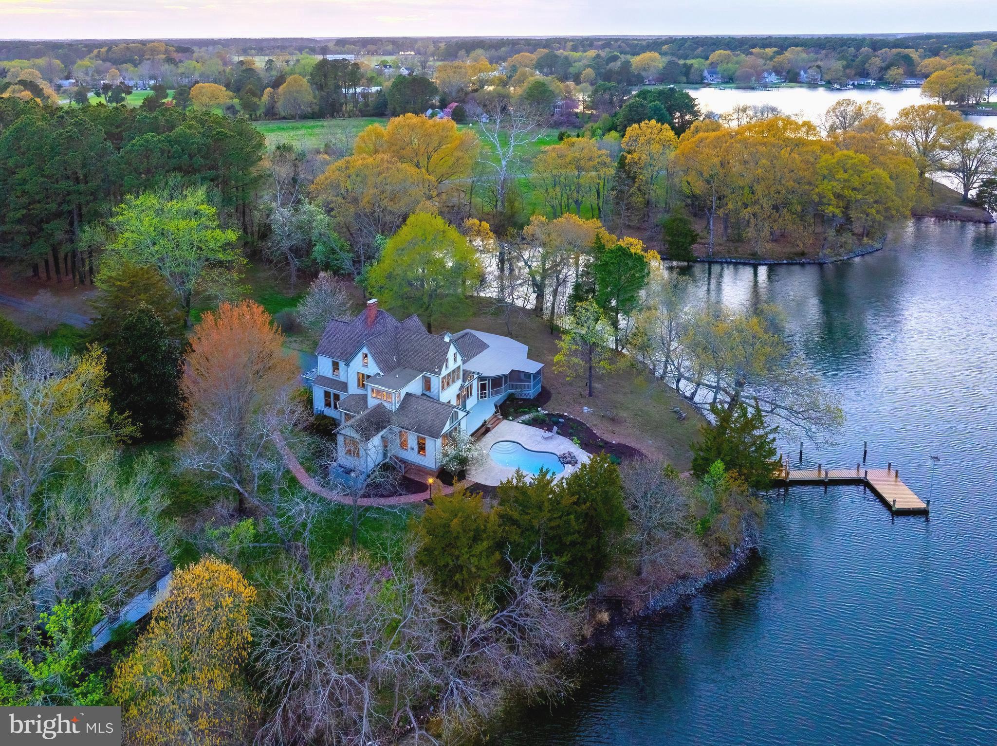 Welcome to Terrapin Point, an extraordinary waterfront estate nestled in the heart of Royal Oak, Maryland—one of Talbot County’s most coveted and picturesque settings. Built in 1890, this timeless Victorian residence evokes the charm of a bygone era, blending old-world elegance with the serene beauty of Maryland’s Eastern Shore. Set gracefully on a private point along the tranquil waters of Oak Creek, the property offers sweeping, uninterrupted waterfront views and a rare sense of peace and seclusion. With minimal boat traffic and protected waters just off the Miles River, Terrapin Point is a true sanctuary for those seeking quiet coastal living and the wonders of nature. 
A long, tree-lined driveway creates a grand and memorable approach, opening to a storybook setting reminiscent of a Norman Rockwell painting. The home itself is filled with natural light and architectural character, including soaring ceilings, elegant archways, and a stunning dining room with exposed beams that overlooks the water—perfectly framing the estate’s breathtaking surroundings.
Designed for both relaxation and entertaining, the home features a spacious kitchen and dining area ideal for hosting, along with an oversize screened porch that invites you to unwind while enjoying gentle breezes off the creek. Outdoors, a beautifully positioned in-ground pool sits just at the water’s edge, offering a resort-like  vacation experience. On the edge of the trees sits a beautifully designed potential "glamping" cabin, art or music studio where you can enjoy the birds singing and watch the light through the trees.
Perfectly located, the property sits equidistant between the charming towns of Easton and St. Michaels, allowing effortless access to renowned dining, shopping, and cultural attractions while maintaining a peaceful, tucked-away feel.
The 12 acre point of land and home embodies the quintessential Eastern Shore lifestyle—refined yet relaxed, elegant yet inviting. A rare offering where timeless architecture, premier waterfront, and an exceptional location come together to create a truly unforgettable property.
*Seller currently resides at the property in the main floor primary suite. Several pictures have been visually enhanced with virtual staging.