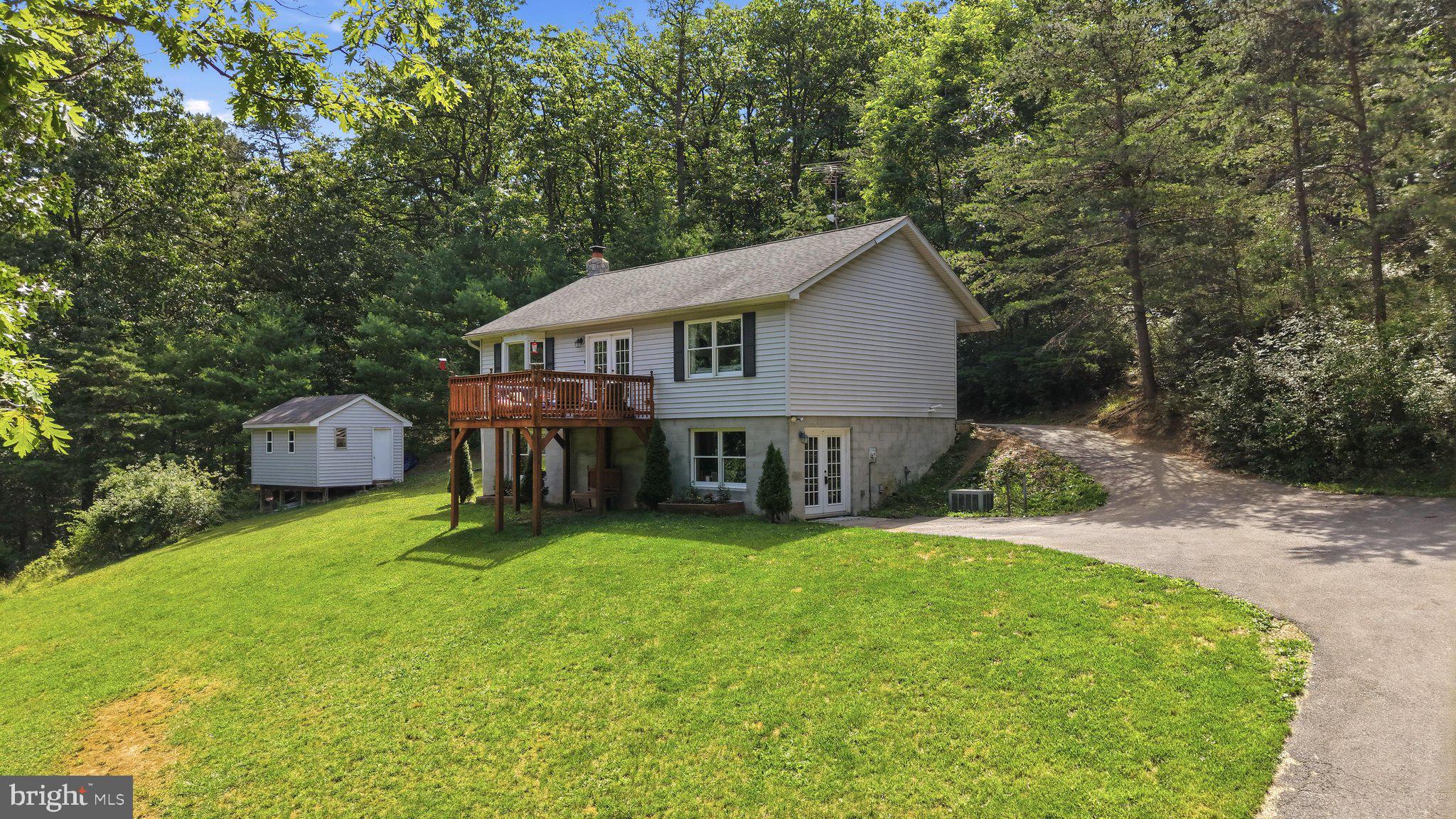 Enjoy Peaceful Country Living on 5 Private Acres!
Experience the best of rural living in this raised rancher, perfectly situated on  just over 5 private acres with exceptional seclusion and scenic surroundings.
The open-concept main level features kitchen, dining and living combination, creating an inviting space for everyday living and entertaining. The main floor offers a comfortable primary bedroom and bath, as well as a second bedroom and bath. Durable laminate flooring extends throughout the home for a clean, modern look.
The lower level includes a third bedroom, a large family room with wood burning fireplace that was cleaned 2 years ago, and an additional versatile room that could serve as a fourth bedroom, home office, gym, or hobby space. No high water and sewer bills with your private well and septic that will soon be pumped and inspected.
Home backs to trees with a storage building for your lawn tools and toys. This is country living at its best!
*Offering $10,000 seller concession with acceptable offer for new roof and painting.