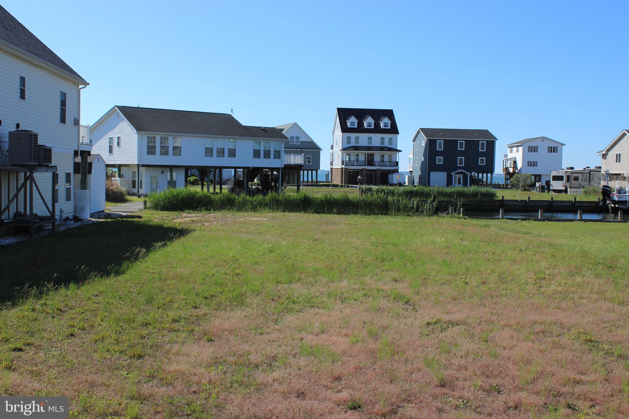 3/1364 It's all about location! Protected canal front lot that offers views of the Chincoteague Bay. Cleared, level lot with approx 60' of bulkhead that has ample room for a boat lift and feeds directly out to the Chincoteague Bay.. Come and see for yourself and you will agree, this is where you'll want to build your dream home! No Builder Tie-In and no time frame to build. To appreciate the view I encourage you to step outside your car and walk to the back of the lot. Great value! HOA amenities: Pristine 9 Hole Golf Course, indoor/outdoor pools (2), fitness center, pickle-ball & basketball courts, playground, boat ramp, picnic area, dog park, biking & walking trails, security and so much more. Call for more information.