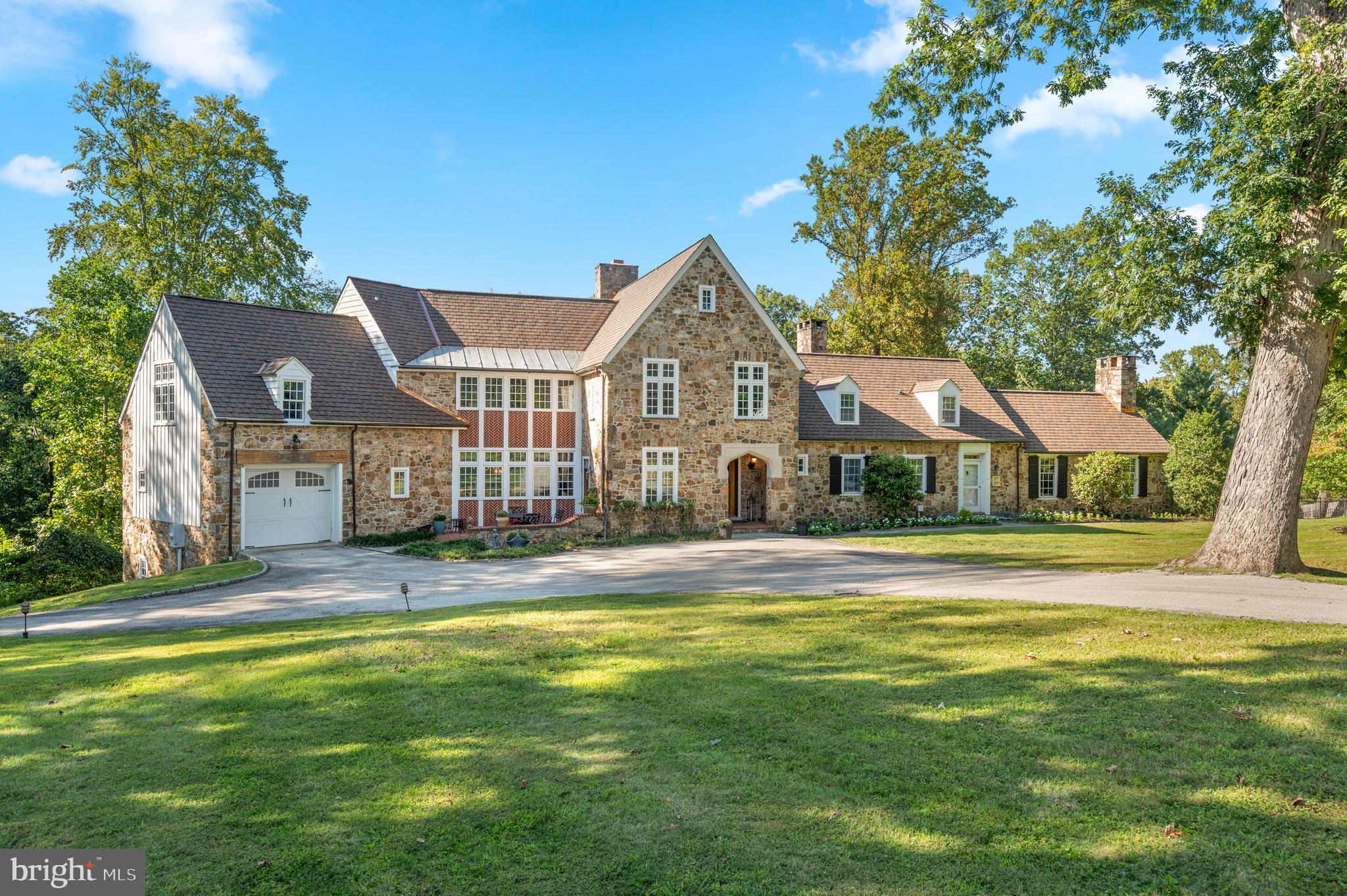 Welcome to 659 Andover Road, a truly exceptional property. This handsome stone manor home immediately captivates with its breathtaking curb appeal and is nestled on 3.15 acres in the premier estate section of Newtown Square. Here you are just steps from Aronimink Golf Club & Episcopal Academy, and 5 minutes to downtown Wayne & the Newtown Town Center. This expansive Archer & Buchanan designed home boasts 6 Bedrooms, 4 Full, 3 Half Baths, and 6,350 sq. ft. above grade and 9,975 sq.ft. total including the finished lower level. 
As you approach the majestic front door, take note of the NEW CertainTeeds’s Grand Manor architectural shingle roof with copper flashing that was just installed this summer! Step into the elegant family room which serves as the heart of the home with timeless coffered ceilings and floor to ceiling French doors that flank the show- stopping fireplace. This room flows effortlessly into a spacious kitchen which has been tastefully updated in 2025 with quartz counter tops & backsplash, lighting fixtures, high-end appliances, and freshly painted custom cabinetry. French doors in the kitchen lead to a massive deck, built in 2020, which offers a covered outdoor space complete with a gas fireplace and an inground pool, creating an ideal setting for outdoor entertaining. Through another set of French doors is the expansive yet intimate dining room.  Continuing through the home, the gorgeous hardwood floors lead to a light-filled office as well as a home library with custom-built cabinetry, both spaces provide the perfect tranquil setting for privacy & focus. An additional front door entrance allows for separate access for professional use if so desired and is adjacent to the office & library as well as the back staircase. Completing the first floor is the star of the home; an extensive vaulted-ceiling pub/game room, offering versatile space that oozes with character and charm.  
The main staircase ascends to the spectacular primary bedroom, which showcases a true sanctuary, boasting vaulted ceilings, a stunning array of windows, sitting area, two spacious outfitted walk-in closets and a luxurious en-suite bath with dual vanities, jetted tub, and an oversized walk-in shower. On the same level, there are four additional bedrooms and two bathrooms. The third floor offers a sixth bedroom with its own bathroom, providing a beautiful private suite perfect for visiting guests or an au-pair. The fully finished lower level of the home includes convenient access to the additional two rear garage bays, with back stairs leading directly into the mudroom. This walkout lower level features a large family room ideal for movies and games, a kitchenette, bonus room and a home gym. With neighboring properties selling up into the $3M+ price range, you don't want to miss this opportunity to call 659 Andover Road your home.