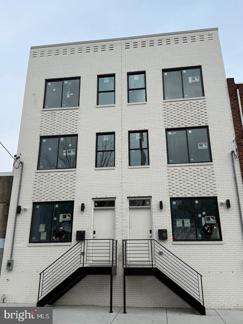Experience elevated city living in this beautiful barely lived in home. The model with all the bells and whistles from an exclusive development of only four residences located in Fishtown. Designed with both style and functionality in mind, this 4-bedroom, 3-bathroom home offers approximately 2,900 square feet of modern living space across multiple thoughtfully designed levels. The main floor welcomes you with a bright, airy layout featuring soaring ceilings, wide-plank engineered hardwood flooring, and contemporary finishes throughout. At the heart of the home is a stunning gourmet kitchen equipped with sleek cabinetry, premium appliances, and an oversized island perfect for entertaining or everyday living. Upstairs, the second level features two generously sized bedrooms and a spacious designer full bath. The entire third floor is dedicated to an impressive primary retreat complete with ample closet space, a spa-inspired ensuite bath, and a wet bar leading directly to a private rooftop deck with sweeping skyline views. The finished lower level offers endless possibilities with an additional bedroom, full bath, and flexible living area ideal for guests, a home office, gym, or media room. Additional amenities include dual-zone HVAC, enhanced security features, still time left on the builder's warranty, and the remaining New Construction Tax Abatement for significant savings. Situated near Aramingo Square Park and just steps from Fishtown’s popular restaurants, coffee shops, fitness studios, and local markets, this home delivers luxury living in one of Philadelphia’s most vibrant neighborhoods.