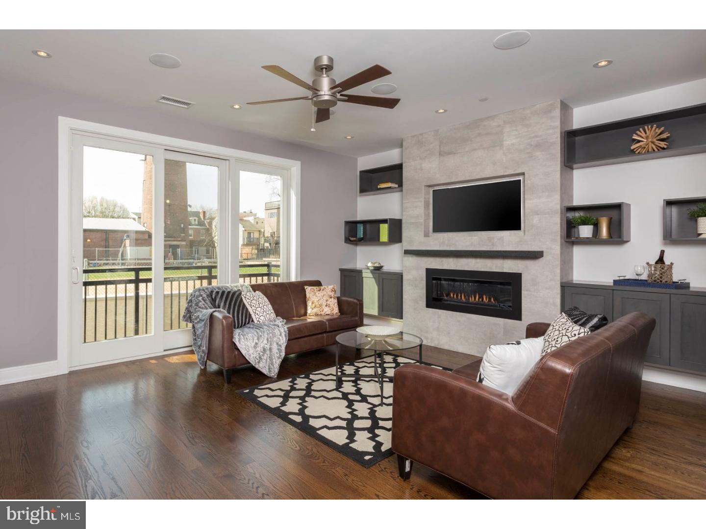 There are just 2 townhomes left! This 4,500 sq. ft. LUXURY home is found at Shot Tower Estates; a 9 unit, new construction GATED development which offers 4 Bedrooms, 3 Full Baths, 2 Powder Rooms, an ELEVATOR and 2 CAR GARAGE parking in Queen Village. Select gorgeous finishes throughout the 19' wide home to create a custom feel. The first floor offers a stunning floating steel staircase, 2 car Garage and Bedroom; great as a home office, located off the front entry with a powder room conveniently concealed. Downstairs, the finished Basement is great for a Guest Suite, In-Law suite, Media room or Gym with high ceilings, a full Bathroom and custom built wet bar with wine frig. Upstairs, the open floor plan was designed with entertaining in mind with a surround sound system, a Living Room with a stunning gas fireplace as the focal point with a tile surround and stone mantle. The professionally designed Chef's Kitchen showcases custom-built cabinetry, an island with bar seating, stone counters, a Wolf/Sub Zero appliance suite with cooktop, stainless floating hood, wall oven, microwave and features cove & under cabinet accent lighting and backsplash. Step outside to a rear deck; excellent for your grill and outdoor dining. The Dining area sits alongside the Kitchen as well as a Powder room; great for hosting dinner parties! The 3rd Floor features 2 large Bedrooms, a full Bath and Laundry room with sink, folding counter and upper cabinetry. 4th floor Master Suite is pure luxury with a gas fireplace in the Bedroom area, THREE walk-in closets and a Spa-like Master Bath with an oversized shower (multiple shower heads), a freestanding soaking tub, heated floors, and a custom double vanity. The pilot house offers a wet bar for serving cocktails while enjoying Fireworks and Sunsets seen from the huge roof deck with outdoor audio and 360 degree views of the city! Whole House audio, 2 alarm key pads, video intercom system and LED lighting throughout are just some of the intricate smart home features that are offered. Oak, stained in place hardwood floors, ample closet space and huge windows for natural lighting add to this custom mini mansion in the heart of Queen Village. Walking distance from many restaurants, bars, cafes, Shot Tower playground/Rec Center and the Delaware River Waterfront. 10 yr tax abatement pending. If you're looking for a QUALITY built home, once inside, you'll discover the extraordinary craftsmanship. Still time to pick your own finishes.