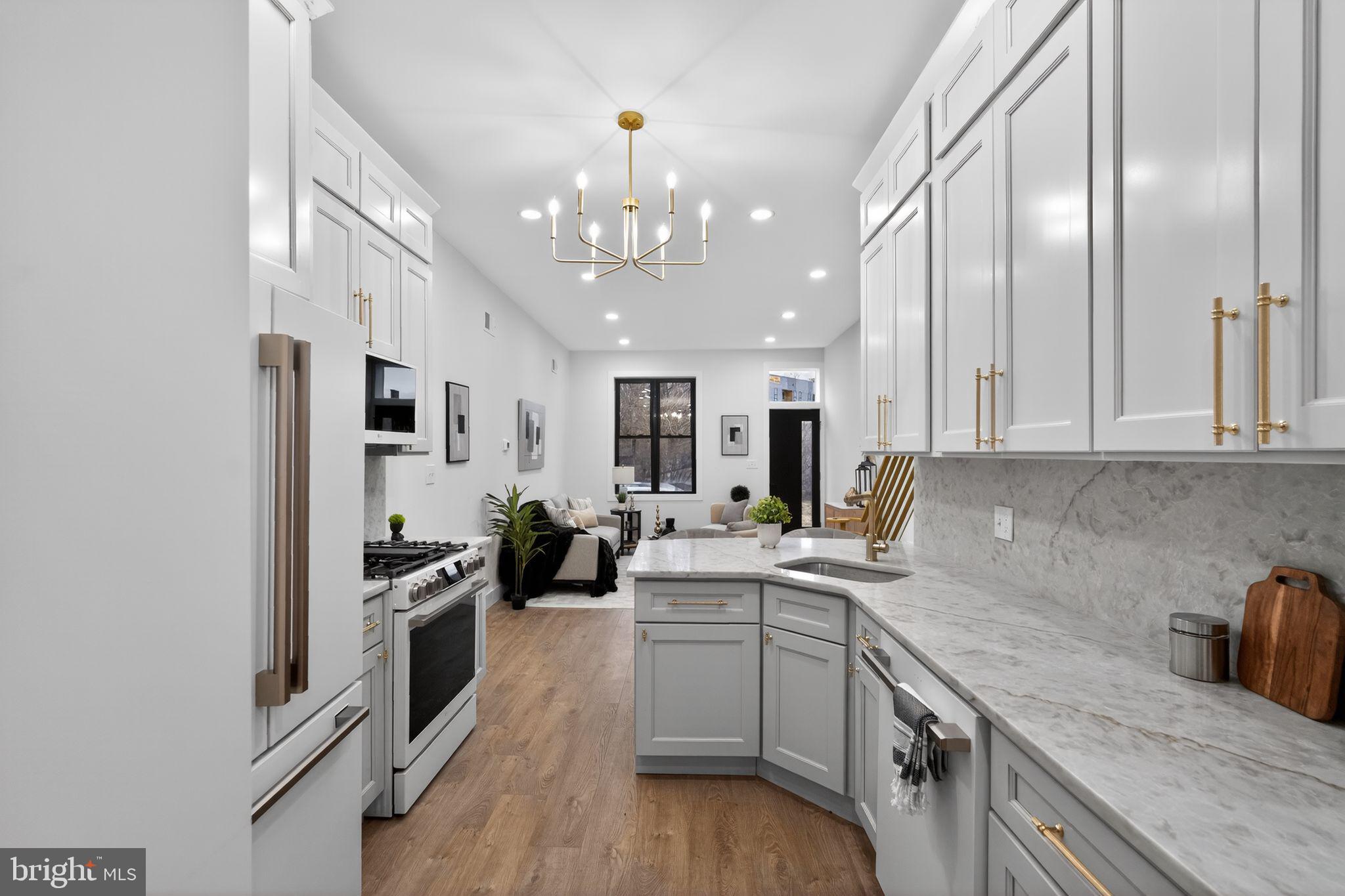 Welcome to 1630 N Patton Street, a professionally styled and architecturally curated residence in the heart of Brewerytown that showcases a truly exceptional renovation. This custom-designed home offers 2 spacious bedrooms, 2.5 bathrooms, and a fully finished basement, with thoughtful design elements and upscale finishes throughout.
From the moment you enter, the home makes a striking impression with brand-new laminate flooring flowing seamlessly throughout the entire property, including the main level, second floor, and finished basement. The main living space leads to a beautifully curated designer kitchen featuring pearl shaker cabinetry, stunning Taj Mahal granite countertops, and a peninsula layout that blends style with functionality. Café Series appliances with rose gold accents, elegant candelabra-style lighting with gold details, and sleek gold-accent railings add to the home's refined aesthetic. New black-framed windows and a custom black entry door provide a bold architectural contrast that elevates the entire space.
Upstairs, you’ll find three generously sized bedrooms with abundant closet space and sophisticated gold accent hardware. The primary suite is a standout feature, offering a spa-inspired, custom-designed ensuite bathroom complete with a double vanity, glazed porcelain tile, and an expansive walk-in shower with glass surround and gold-accent fixtures. A second full bathroom is equally impressive, showcasing a beautifully finished shower with wood-tone ceramic tile and designer accents. A stylishly renovated half bath is conveniently located on the main level.
The fully finished basement adds flexible living space perfect for a media room, home office, gym, or guest area, and has been finished to match the home’s clean and modern design. Additional upgrades include brand-new HVAC with central air and a rear yard space ready to be transformed into your own private outdoor retreat.
This professionally curated Brewerytown residence blends modern luxury with thoughtful craftsmanship, creating a home that is both sophisticated and comfortable in one of Philadelphia’s most vibrant and growing neighborhoods.