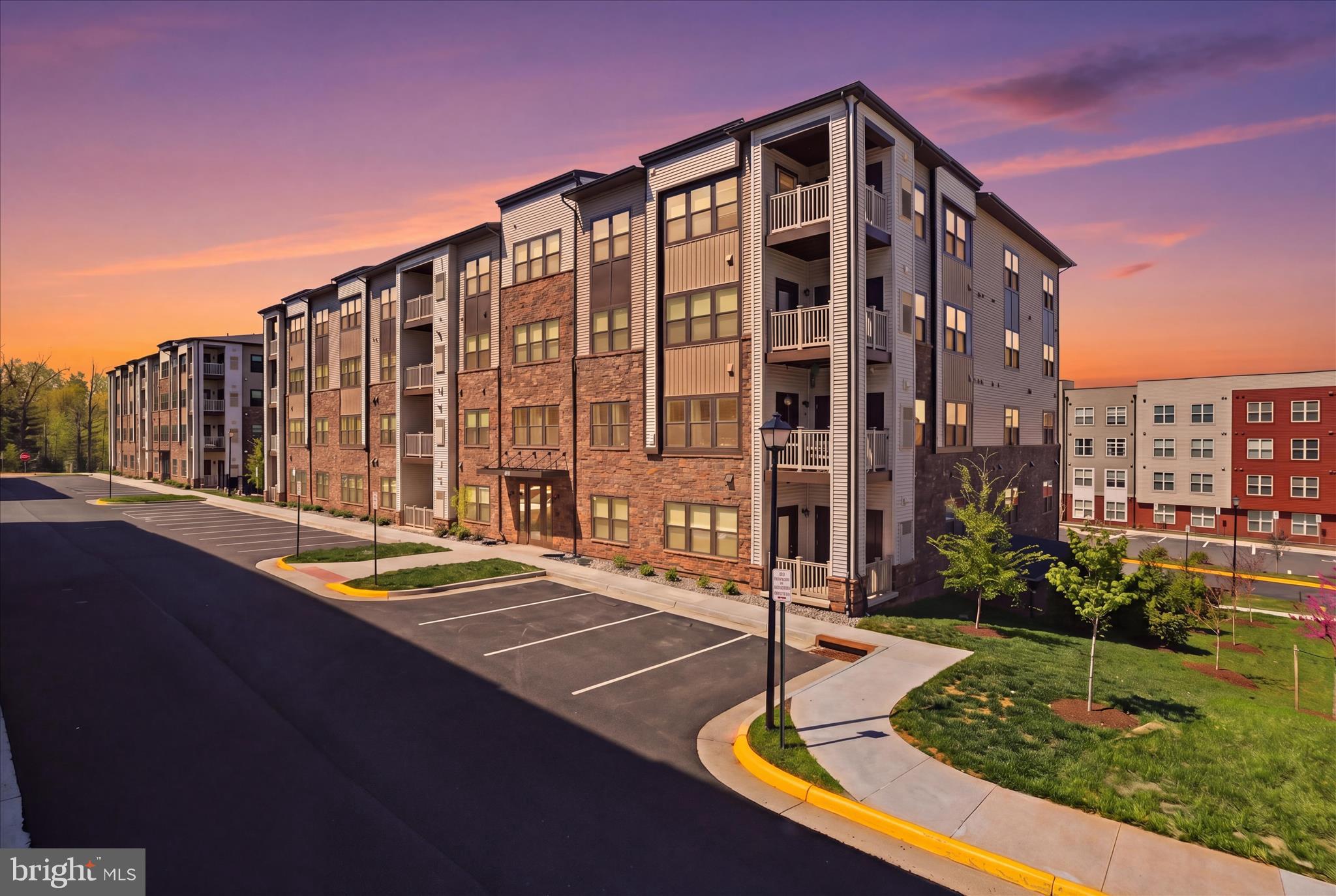 Welcome home to Loudoun View Condos near Cascades Overlook Town Center! This gorgeous nearly new two-bedroom, two-bathroom 2023 build condo is perfectly situated on the first floor for easy outdoor access. Thoughtfully designed for both comfort and functionality, the well-appointed residence features a spacious and open layout. The expansive living and dining room serves as the heart of the home, offering abundant natural light and seamless access to a private balcony, perfect for relaxing or entertaining. The kitchen is conveniently located off the bright main living area and includes loads of storage space with crisp white, soft close shaker cabinets, stainless steel appliances with gas cooking, and a functional workflow ideal for everyday living. The primary suite is privately situated and features a generous walk-in closet and an en-suite primary bathroom, providing a comfortable retreat. A good-sized second bedroom offers flexibility for guests, a home office, or additional living space, and is conveniently located near the hall bathroom. Additional highlights include multiple closets for storage, a dedicated laundry area, and a separate storage room off the balcony, enhancing everyday convenience. Enjoy the ease of an indoor garage space, offering protection from the elements year-round. Modern and safety amenities include elevator access, Ecobee thermostat, front lobby security system that can be monitored on your phone and card entry for your reserved underground garage parking spot. Plenty of additional parking is also available throughout the community. Take advantage of the community's half basketball court, pickleball court, tot lot and refreshing outdoor pool, just steps away from your front lobby door. You will appreciate the proximity to the nearby Harris Teeter shopping center and a variety of restaurants. Target and Costco are also conveniently located just around the corner. For those seeking excitement, explore entertainment options at Top Golf, IFLY indoor skydiving, or enjoy outdoor activities at Claude Moore or the indoor facility that includes an indoor pool, basketball courts & gym. Dulles Mall, Reston Town Center, and Tysons Corner. Ideally located near Route 7 and 286, you are just steps from Cascades Overlook Town Center, Potomac Run Plaza, Target, Costco, and a wide range of dining, grocery, and entertainment options, all within half a mile. Enjoy a low maintenance, move-in ready home designed for easy living!