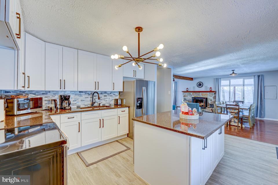 This STUNNING TURN KEY FULLY FURNISHED with everything in the house included, sitting on over an ACRE of LAND completely RENOVATED with CUSTOM UPGRADES: GRANITE AND TILED KITCHEN, center ISLAND, CUSTOM BATHROOMS, TILED/ HARDWOOD FLOORING throughout the house, GEORGEOUS WOOD PLANK WALLS making you feel at home as soon you walk in. Huge PRIMARY SUITE with walk in closet and PRIVATE BALCONY. Large LIVING ROOM with NATURAL STONE FIREPLACE TO cozy up after a day of skiing, MEDIA ROOM, POOL ROOM, SAUNA to reduce daily stress or just RELAX with friends on weekends. BEATIFUL wrapped around covered PORCH to enjoy hot summer nights. Did I mention the OVERSIZED 2 CAR GARAGE with GAME ROOM/ WORKSHOP above. House is filled with NATURAL LIGHT. Don's miss this one. Heart of the Poconos minutes from all Major Attractions and only 2 hours from NYC. Close to Rt 80, shopping, Mt. Airy Casino, minutes away from water parks: Kalahari Resort, Camelbeach, Aquatopia, Camelback Skiing resort, state parks, water sports, hiking, fishing, and more.
