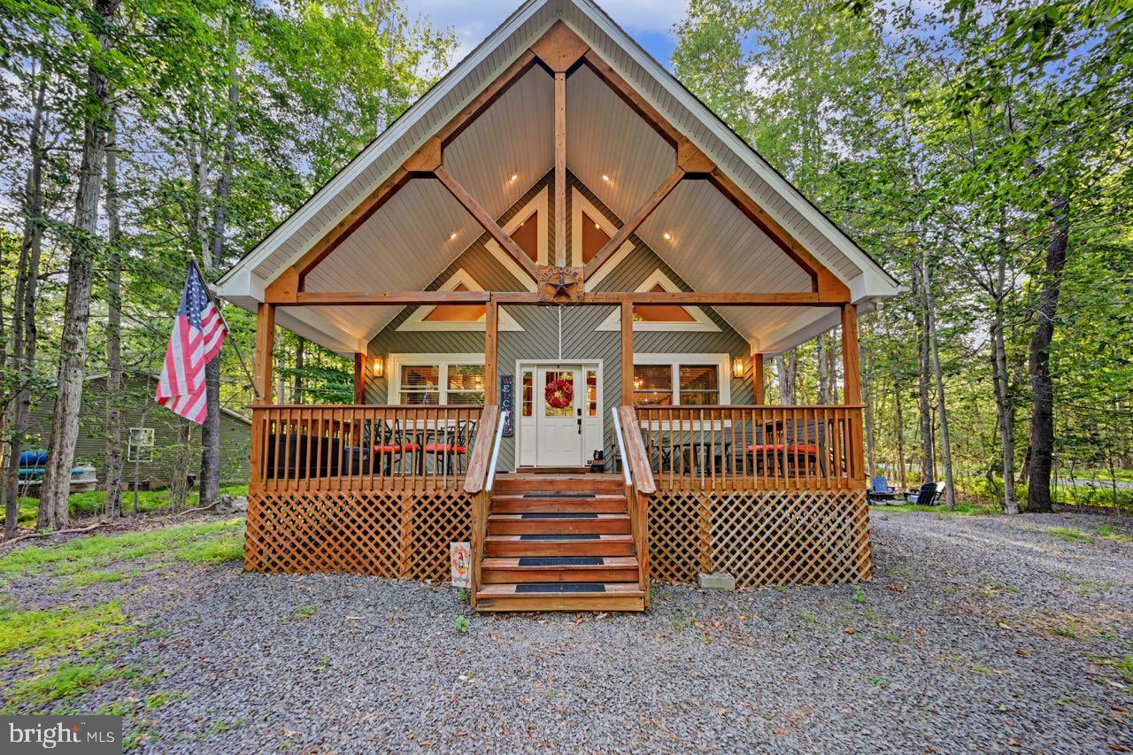CLASSIC POCONO MOUNTAIN CHALET PERFECTION! Majestic inside and out, this stunning chalet is everything buyers dream about when they picture a mountain retreat. From the moment you arrive, the iconic chalet architecture and spectacular covered front porch create an unforgettable first impression, inviting you to slow down, relax, and soak in the mountain atmosphere. Built in 2009 and beautifully maintained, the interior is every bit as impressive. The soaring, wide-open family room is anchored by a striking fireplace, creating the perfect gathering space for cozy evenings after a day on the lake or the slopes. Warm, serene colors throughout the home complement the natural surroundings and make every room feel welcoming. The thoughtfully designed floor plan offers two bedrooms and a full bath on the main level, while the entire second floor is dedicated to an incredible primary suite--a true private retreat featuring generous space to unwind after a day of adventure. Situated on a spacious corner lot, you'll enjoy extra room both inside and out with plenty of space for entertaining, relaxing around the fire pit, or simply enjoying the fresh mountain air. Every angle of this home captures the timeless charm that has made Pocono chalets so sought after. Located in Arrowhead Lake, one of the Poconos' premier gated communities, you'll have access to two beautiful lakes, four sandy beaches, three outdoor swimming pools, playgrounds, fitness facilities, tennis and basketball courts, and an endless calendar of activities and events throughout the year. Golf-cart friendly and packed with recreation, Arrowhead Lake offers the mountain lifestyle buyers are searching for. Whether you're looking for a full-time residence, weekend escape, or investment property, 5376 Conoquenessing Drive is the classic Pocono chalet that truly has it all. This one is an absolute stunner.