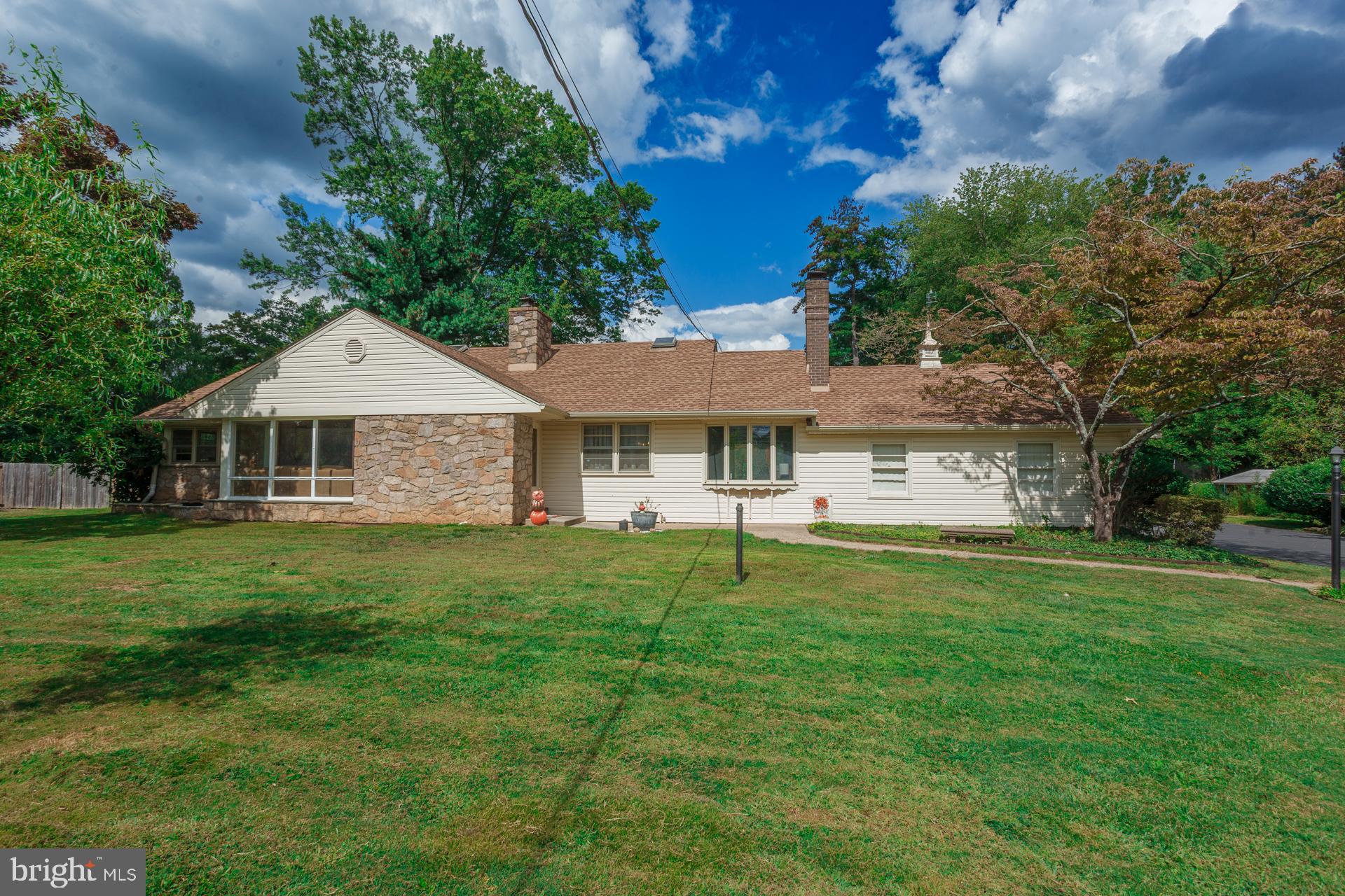 Spacious Custom Ranch with Second-Floor Addition in Council Rock School District. Discover this beautifully crafted ranch-style home with a flexible second-floor addition, located in the highly regarded Council Rock School District. Featuring 5 bedrooms, 3 full bathrooms, and 4 garage spaces (2 attached, 2 detached), this home blends comfort, convenience, and timeless charm. Inside, a sun-filled living room welcomes you with dramatic floor-to-ceiling windows and a cozy wood-burning fireplace. A formal dining room connects seamlessly to the family room, creating the perfect gathering space. The kitchen, enhanced by skylights, offers abundant natural light and a warm, inviting atmosphere for cooking and entertaining. The main level offers the ease of one-floor living with three bedrooms, including a spacious primary suite, two additional bedrooms with ample closets, and two full baths. One bedroom was converted into a laundry space, but the setup could be relocated to the basement where the original hookups remain.  The second floor features two more bedrooms, a full bath, and access to a large walk-in attic with a whole-house fan—providing plenty of storage or potential for expansion. Perfect for hobbyists, collectors, or car enthusiasts, the property includes four garage bays. The oversized detached garage also boasts a second-level space—ideal for a workshop, studio, or additional storage. Outdoors, enjoy a charming back patio overlooking the fully fenced, expansive yard, perfect for entertaining, gardening, or simply relaxing in your own private retreat. Recent updates include a professionally waterproofed finished basement, a chimney treated with Heatseal ceramic coating with a 20 year warranty, and a new well and Water softener, giving you added peace of mind. This exceptional property offers space, versatility, and a prime location in a top-rated school district. Don’t miss the chance to make it yours!