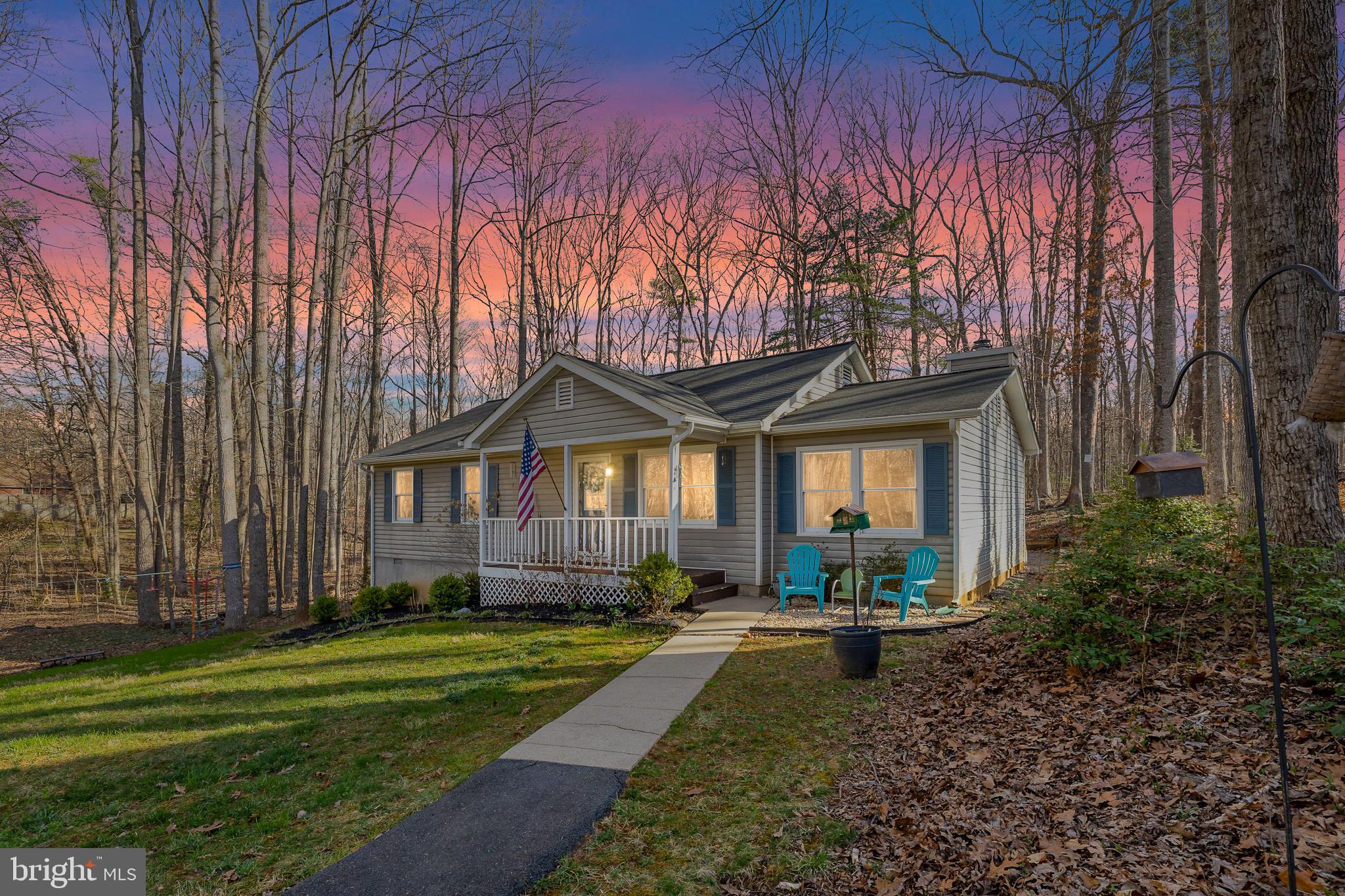 Escape to the tranquility of rural living with this charming one-level retreat that perfectly blends comfort with the great outdoors. Nestled on a serene lot backing to pristine national parkland, this home is a nature lover’s dream—offering endless hiking, wildlife sightings, and the peaceful seclusion you crave.

Step inside to find a welcoming living room that flows effortlessly into a well-appointed kitchen, ready for home-cooked meals after a day of exploring the great outdoors. A cozy step-down family room provides the perfect space to gather  or unwind with views of the surrounding trees.

The primary bedroom offers a peaceful retreat, while two additional bedrooms and a hall bath provide ample space for family or guests. Outside, the spacious deck is ideal for morning coffee, evening stargazing, or simply soaking in the sounds of nature.

Whether you’re drawn to the charm of front porch sitting, the thrill of outdoor adventures, or the serenity of a home surrounded by protected land, this property offers the perfect balance of comfort and connection to nature. Come experience the beauty of rural living—schedule your private tour today!