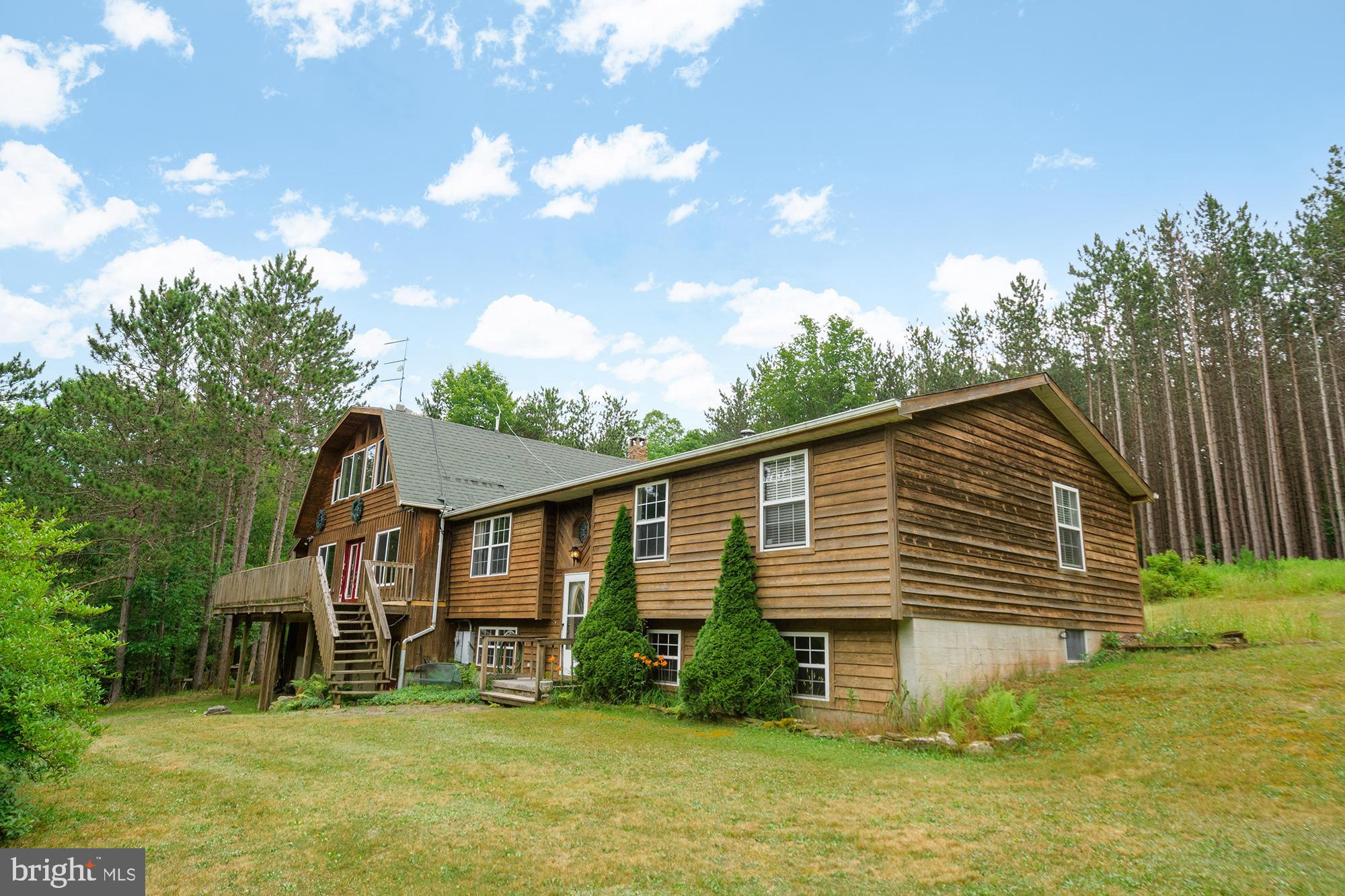 Escape to your own private sanctuary with this stunning 5-bedroom, 3-bathroom home nestled on 3.22 acres. Featuring a cozy fireplace, an open kitchen, a custom-built great room, and expansive windows that invite the forest views inside, this retreat is perfect for those looking to get away from it all. The decks and porches offer serene spots to relax and soak in the beauty of nature.

As you enter the home, a few steps lead you to the kitchen and dining area, complete with a large kitchen island and a sliding glass door to the back. Down the hall, you'll find three bedrooms and two bathrooms. To the left is the great room, an addition to the original home, boasting high ceilings and abundant natural light. The primary bedroom is located upstairs with its own bathroom. The basement includes an additional bedroom, several versatile rooms, a laundry area with a washer and dryer, a half bath, and a two-car garage.

Surrounded by red pines in the backyard, this rare gem also features several sheds, a firepit, and a mix of fields and trees. Enjoy the convenience of easy access to I-68 while feeling completely secluded in this private haven.

Heating systems include:  Original right side of house uses a Pellet stove, has electric baseboard heating and a heated kitchen and dining room floor.  The new side of the house uses a wood or coal burning stove and the fireplace uses Propane.

The seller is offering a $10,000 credit for a new heating system with a full price offer.  The amount is negotiable with all other offers.   Motivated sellers!!!!!

Schedule your tour today!