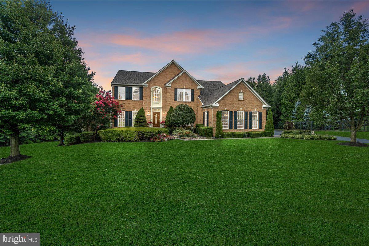 Welcome to this stunning, former model home, ideally situated on over an acre of beautifully landscaped, private wooded corner lot, in the highly sought-after community of Sun Valley, Carroll County. Bright and airy throughout, this home was thoughtfully designed for both everyday living and elegant entertaining, showcasing luxury finishes and exceptional attention to detail. No HOA fees to worry about! Inside, you'll find five spacious bedrooms and four and a half bathrooms. Elegant crown molding, chair rail molding, box wainscoting, lighted tray ceilings, and an intercom/audio system on all three levels add richness and character to the home's interior. The main level boasts a beautiful dining room and formal living room, with columns separating the two spaces, a large sunroom, office with French doors, and an extra-large family room with gas fireplace. The impressive open kitchen was renovated in 2021 featuring granite countertops and high-end stainless steel appliances including an area for a large kitchen table, and upgraded ceramic tile flooring.  The expansive primary suite includes two custom walk-in closets, a comfortable sitting area, and a spa-like bathroom with Tuscan-style columns, chandelier, built-in heater, and a large soaking tub - perfect for unwinding at the end of the day. The fully sound-insulated, walkout basement offers privacy and comfort, featuring a game/billiards room, pre-wired theater room, craft room showcasing tailored built-in cabinetry with integrated lighting and counter workspace, additional bedroom with a custom floor to ceiling lighted and wired built-in wall unit, and full bath - ideal for guests, live-in help, or multi-generational living. The basement also includes integrated multi-location TVs, custom closets, and built-in storage, ensuring organization and convenience throughout. The walkout basement leads to a charming brick patio, with electric service already in place for a future hot tub. The main level laundry room with its custom built-in cabinetry is conveniently located, entering the fully-finished 3-car garage complete with a durable epoxy floor. A custom-built, fully lighted shed is seamlessly integrated beneath the deck, providing additional exterior storage without impacting the beauty of the lot. Outside, the home continues to impress. A spacious, multi-level deck offers an ideal space for entertaining and enjoying the stunning sunset views. The entire yard has been professionally landscaped featuring trees specifically chosen for their vibrant and varied fall colors, creating a beautiful backdrop year after year. Sportdog invisible fence system is included to enable your dog free and safe rein of the entire yard! Landscape lighting around the property, ensuring that its charm shines both day and night. This property is centrally located - with easy access to Eldersburg, Westminster, and Mt. Airy - and combines elegance, comfort, style, and function - welcome home!