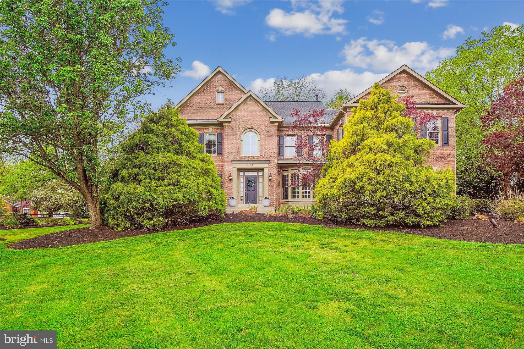 This stately 8 bedroom, 6.5 bath Colonial sits on just over two acres in the beautiful neighborhood of Hunting Hill Estates and highly rated  Wootton school district.  Follow the cul-de-sac up the idyllic cherry-lined driveway to this massive four level home with mature trees and spectacular landscaping.  The front features a gorgeous slate walkway and extensive outdoor lighting.  The heart of this home is a beautifully renovated white kitchen with custom cabinets, quartz countertops, a spacious island, subway tiled backsplash and stainless appliances including Subzero refrigerator and a Wolf dual fuel range with double oven, 6 burners, griddle and oversized stainless steel hood .  The kitchen features a walk-in pantry and opens to a built-in banquette (with storage) and sunroom filled with natural light – the perfect spot to enjoy your morning coffee. The backyard, accessible via the sunroom or back gate, is a beautiful oasis featuring a huge Koi pond, soothing waterfalls, slate patio and circular fire pit.  Directly next to the kitchen is a large step-down family room with gas burning fireplace and a second staircase to access the upper level.  An office with a beautiful bay window overlooking the front yard, a dining room with coffered ceiling, a generous living room, a powder room and mudroom connecting to a three car garage completes the main level.  The second level features five bedrooms including an oversized two room primary suite (a great spot for a 2nd office, work-out area or reading nook) with spacious ensuite bath with double sinks, large soaking tub, shower, private toilet room and oversized walk-in closet. Upper level also includes two ensuite bedrooms with walk-in closets and two additional bedrooms that share a Jack and Jill bath.  The third attic level offers one bedroom with a spectacular view of the expansive property, a bonus room - perfect for guests or as an office, a large hall walk-in closet and the fifth full bath.  The finished walk-up lower level includes nine foot ceilings in the enormous recreation room boasting ceramic tiled floors, tons of natural light, two additional bedrooms, a sixth full bath, ample storage, large laundry area and utility. Hardwood floors throughout main and upper levels and loads of storage is offered throughout the home.  This meticulously maintained home has a newer roof (2018), and ample parking for multiple vehicles and access on McCrossin Lane. Nestled in a picturesque neighborhood, this home offers the best of Suburban life with abundant nature and convenient access to multiple shopping centers (RIO, Crown, Kentlands). This home is perfect for multi-generational living, or just those looking for lots of space!