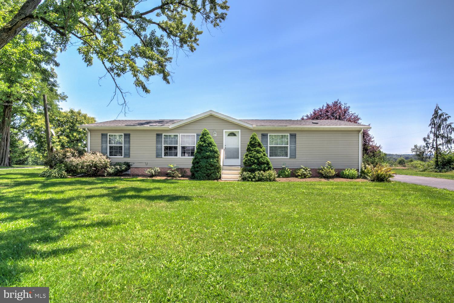 Better than renting! This is a fantastic opportunity to own a 3-bedroom, 2-bath home with over 1,400 square feet of living space for under $250,000 on your own 1/3 acre lot! This 2001 manufactured home offers the perfect combination of affordable country living, open space, and scenic farmland views. Thoughtfully updated over the years, the home features a new roof (2021) and a new propane furnace and central air conditioning system (2023), giving buyers peace of mind on two of the home's biggest improvements. Inside, you'll find an inviting open floor plan with a spacious living area, a convenient first-floor mudroom/laundry room, and three generously sized bedrooms. The primary suite includes a private full bathroom, creating a comfortable retreat at the end of the day. Step outside onto the rear deck and enjoy a peaceful backyard that overlooks surrounding farmland—an ideal setting for relaxing summer evenings, entertaining guests, or simply taking in the country views. If you've been searching for an affordable home with modern updates, generous living space, and a beautiful rural setting, this one is not to be missed!