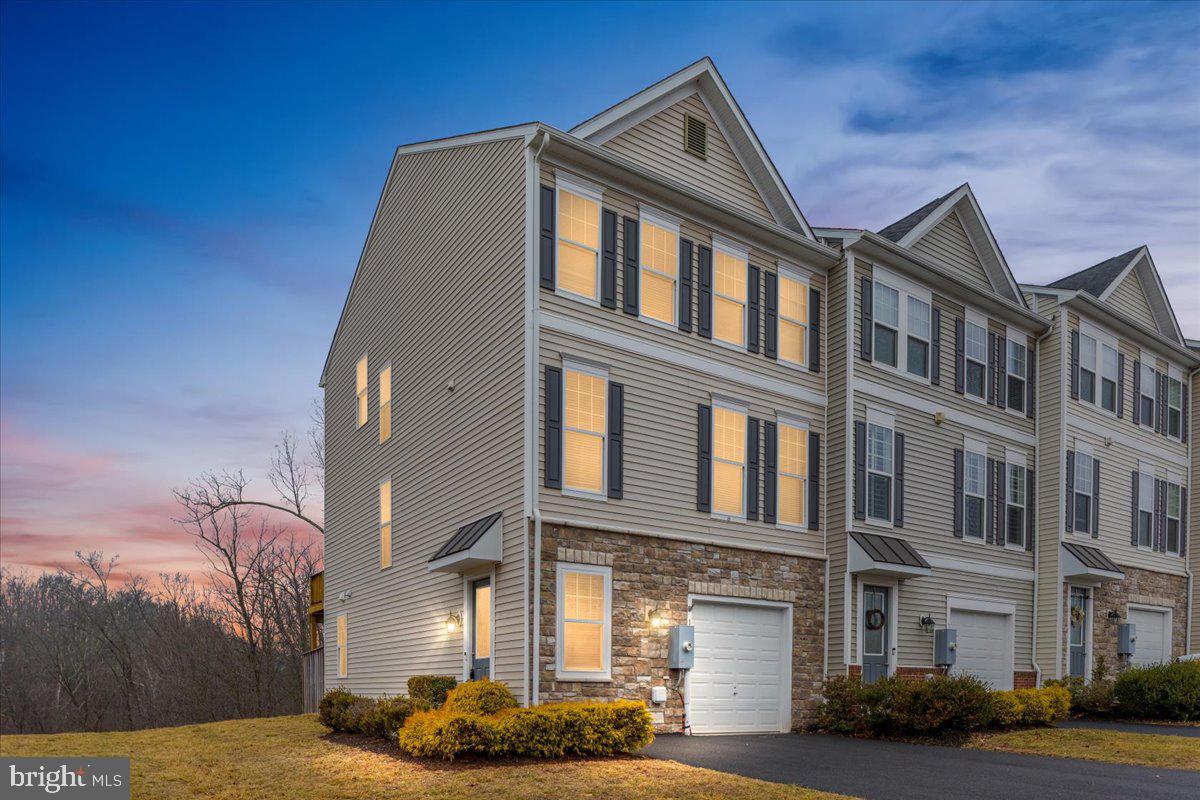 Some homes check the boxes. Others quietly stand apart the moment you pull up. This one does that. Not because it tries to impress, but because the setting, the layout, and the way the house sits on the land just make sense. <br>
<br>
Start with the lot. It’s a premium double-sized end-unit lot, something you simply don’t see often in townhouse communities. The home sits at the edge of the neighborhood, giving it a quiet, almost cul-de-sac feel with less traffic and more room to breathe. Behind the house you get privacy. Right beside it sits the neighborhood playground, close enough to enjoy the open space but without sacrificing the feeling that this corner of the community belongs to you.<br>
<br>
Inside, the home gives you over 2,200 finished square feet spread across three levels, with three bedrooms and three-and-a-half baths. The layout is open where it should be and comfortable where it matters most. Hardwood floors run across the main level, grounding the living space and tying everything together.<br>
<br>
The family room centers around a gas fireplace framed by built-in bookcases, the kind of feature that makes the space feel finished and welcoming. It’s easy to picture quiet evenings here, the fire going, books within reach, and the room settling into that calm rhythm a home develops over time.<br>
<br>
The kitchen and dining area flow naturally out to a large deck just off the back, making it easy to step outside and take in the open space around the home. It’s the sort of deck that quickly becomes part of everyday life: morning coffee, evening conversations, or simply stepping out for a breath of air.<br>
<br>
Upstairs, the primary suite offers a little extra comfort where it counts. A tray ceiling adds dimension, the walk-in closet gives you real storage, and the large walk-in shower in the primary bath keeps the space feeling clean and uncluttered. Granite countertops carry through the kitchen and bathrooms, while designer paint selections give the interior a polished, intentional feel.<br>
<br>
Practical features are here too. The attached garage keeps daily life easy, and the position of the home within the community means more available parking and less through traffic than you’d typically expect in a townhouse neighborhood.<br>
<br>
What really sets this property apart, though, is how it lives. End unit. Double lot. Privacy behind you. Open space beside you. A layout that works and a setting that feels calmer than most.<br>
<br>
It’s the kind of home that quietly grows on you the longer you stand there.<br>
<br>
Walk the lot. Step out on the deck. Look around and notice how much space you have compared to everything else nearby.<br>
<br>
Once you do, you’ll understand why this might be the best lot in the neighborhood.