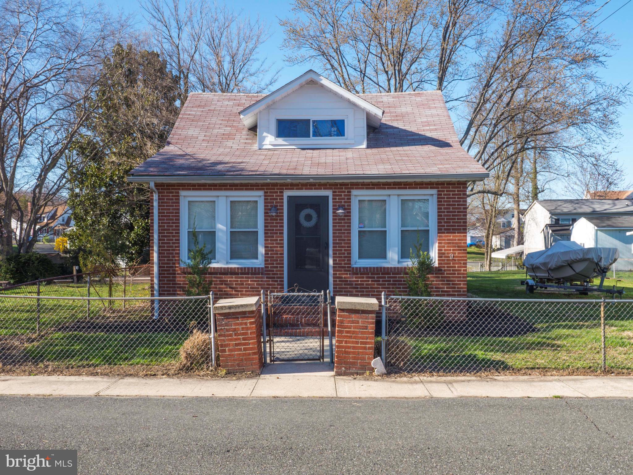 Cute as a button, this 3 level cape cod has been remodeled.  Beautiful kitchen with cherry 42" cabinetry, corian countertops, stainless appliances, island and eat in area. Enclosed back porch overlooks very large fenced yard housing 4 lots altogether.Home is all brick, has hardwood flooring in living room and hallway/office area. Just blocks from the Bay, shopping, restaurants, boardwalk &. more..