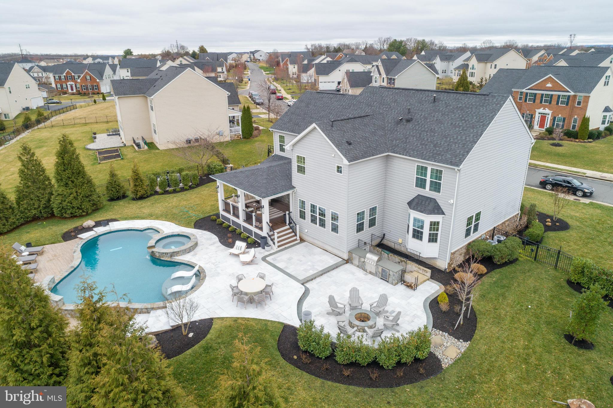 Enhance your living experience with this exquisite property nestled in the highly coveted Dawson's Corner neighborhood. This stunning home is an entertainer's dream and has an amazing backyard oasis featuring a 25,000 gallon heated smart salt water pool with fountains, 8 person hot tub with spillover, LED changing color lights, 2000+ sq.ft. travertine & porcelain paver multi level patio, outdoor kitchen & fire pit, outdoor speakers and a huge covered composite deck w/ stone wall, tv, lighting and ceiling fan. The main level features an amazing remodeled gourmet chef's kitchen with an expansive center island, upgraded cabinetry & appliances, sleek Calacatta Laza Quartz counters & backsplash, cooktop w/ pot filler, breakfast bar and a great sun filled breakfast room. Situated off the kitchen is a cozy family room with new carpet, a remodeled fireplace with quartz surround, custom wood mantle and board & batten wall accents. Complimenting the main level is a formal living room with crown and chair moldings, a formal dining room with tray ceiling, bay window and moldings. Completing the main level is a great home office with custom built-ins, a custom mudroom and a stylish half bath. Ascend to the upper level to discover an indulgent owner's suite featuring a tray ceiling, a sitting room, double walk-in closets, luxury owners bathroom with dual vanities, soaking tub and separate shower. Rounding out the bedroom level are 3 generous bedrooms, 2 full bathrooms and a laundry room. Venture downstairs to the walk-up basement with an enormous rec room with rough-in plumbing for a wet bar, theatre room with projector & screen, sizeable den and full bathroom. Additional property features include over 500k in updates, a front porch, 2 car side load garage, professionally landscaped front & rear yard, mature Evergreen trees for added privacy, aluminum fenced rear yard, 5" engineered hardwood flooring on the main level, new carpet on the bedroom level, updated custom modern trim throughout, over 5200 sq.ft. and so much more! Don't miss the opportunity to make this exquisite property your next home! Schedule a showing today and experience unparalleled luxury living! Minutes to shopping, dining, grocery, major commuter routes of Rt. 29, Rt. 50, I-66 and Dulles Airport.