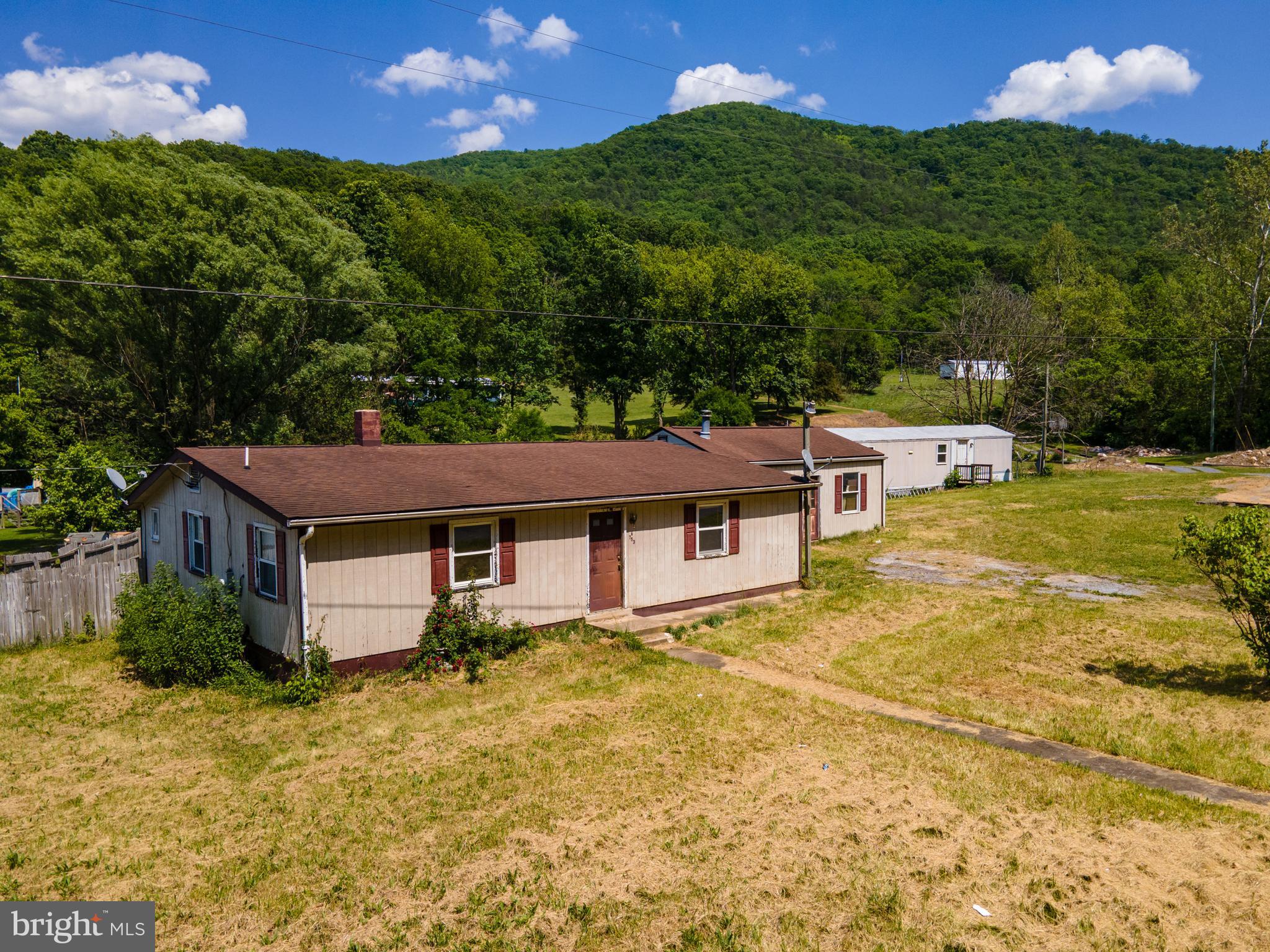 Multi Unit Property in Steam Hollow!  This property consists of a 2 BR 1 BA house, a 3 BR 1.5 BA singlewide trailer and a 1 car detached garage! The potential is in place for this property to be income producing! All structures are in need of repair in order to be livable. The property is situated at the end of a state maintained road allowing for convenient access with privacy. This property is being sold strictly in "as-is" condition.