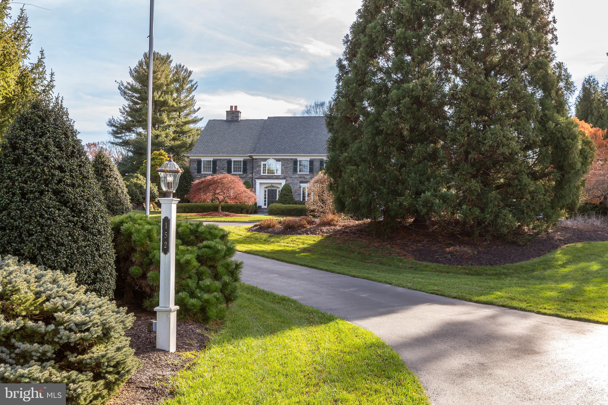 Welcome to 152 Grubb Road, an impressive, meticulously maintained 5 bedroom, 4+ bathroom stone colonial set on 2.24 acres in a sought after Willistown location. An ideal location with all the accessibility and esteem of the Main Line, yet the charm and open space of Chester County, you can truly enjoy privacy and convenience. Boasting a circular driveway highlighted by lovely landscaping, stone exterior and Grand Manor roof and an attached 3 car garage, 152 Grubb was designed for modern living and entertaining, yet pays homage to traditional Main Line architecture.

This home couldn’t be better suited for entertaining, with a welcoming 2-story foyer flanked on either side by formal living and dining rooms. Elevated design choices follow you throughout the home, including high-end fixtures, elegant millwork rarely found in homes of this vintage, and Brazilian Cherry hardwood flooring on the main level. The kitchen is a home chef’s dream, including granite countertops, an impressive Sub-Zero refrigerator, stainless steel appliances, gas cooktop, pantry, center island with seating and prep sink, and a sun-filled breakfast/morning room. A step-down family room with a coffered ceiling and built-ins opens to the rear patio where you can take in the gorgeous views of your backyard. A truly impressive spacious study with wood paneling and built-in shelving  makes working from home a breeze. The main level conveniently features two powder rooms, a mudroom, and a rear entry to the foyer, making it ideally suited for modern living. Upstairs, the spacious primary suite offers two walk-in closets and a luxurious bath with soaking tub, separate shower, and dual vanities. Additional bedrooms, multiple full baths, second-floor laundry, unfinished walk-up attic, and daylight lower level provide excellent flexibility. Head outside to enjoy the home’s lovely setting on a large lot offering an ideal blend of privacy and open space. An added bonus, 152 Grubb features a generator— a lifesaver during unpredictable weather conditions. 

Within sought-after Great Valley School District, 152 Grubb boasts an unbeatable location, conveniently surrounded by the towns of Malvern, Paoli and Berwyn with their independent shops, restaurants, bakeries, coffee spots, and libraries. Also nearby you’ll find easy access to Regional Rail and Amtrak service, the Upper Main Line YMCA, parks and trails including Fox Hollow trail for morning walks, and prestigious golf clubs and Radnor Hunt Club. 152 Grubb enjoys a seamless blend of Chester County’s tranquility and the Main Line’s accessibility— come and see for yourself!