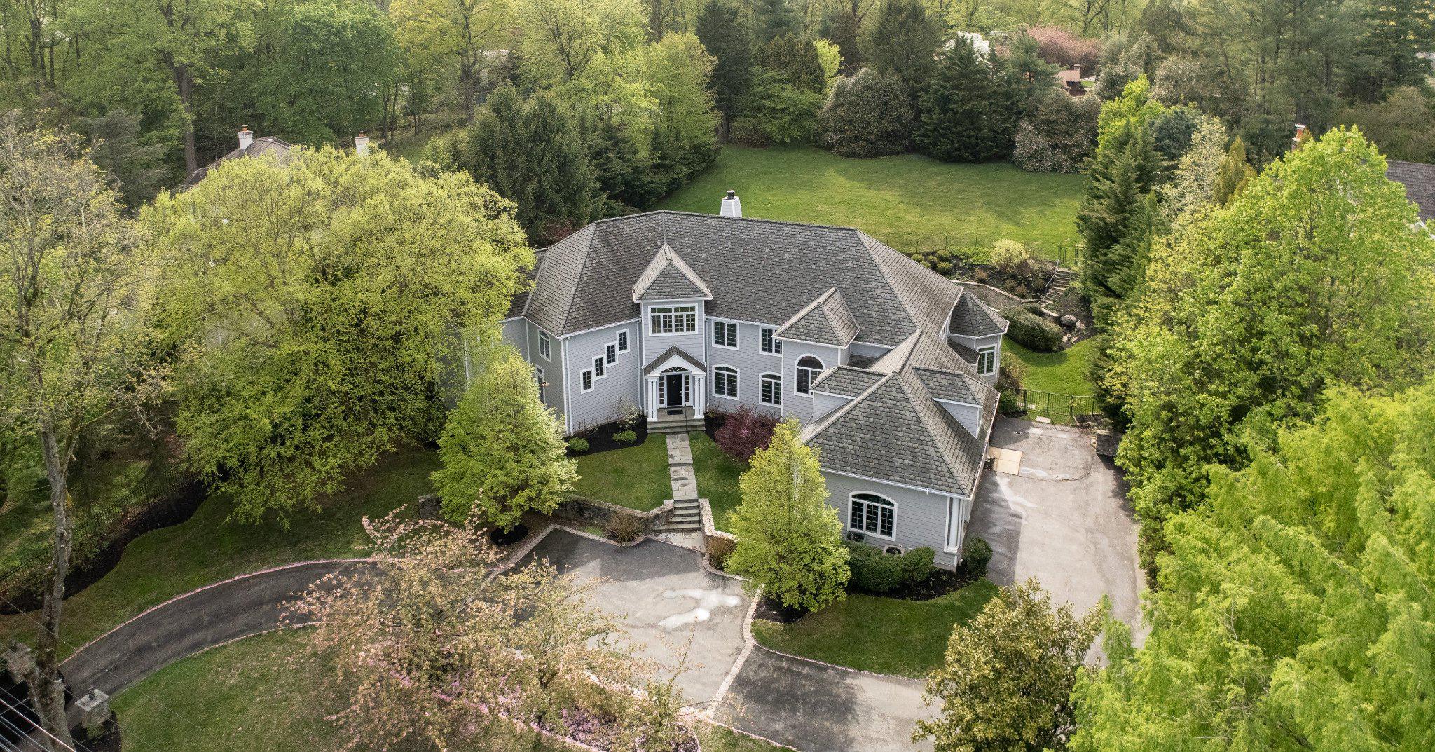 Please note- Saturday, April 25, 2026  Open House Canceled. Last year, to make their home perfect, the current owners of one of the prettiest North Bryn Mawr homes in Lower Merion completed a Hardie-Plank recladding of 952 Lafayette Rd.  This stunning, sun-filled, modern masterpiece, on over an acre, has much more than a pretty wrapping. Step inside into a dramatic two-story center hall foyer, with sophisticated artistic marble tile and abundant natural light through fabulous, oversized windows. It is your entrance to an open floor plan and design that functions fantastically for both easy everyday living and effortless sophisticated entertaining. Highlights include: A breathtaking gourmet kitchen featuring a 10-foot polished, premium granite, topped island, more counters with leathered granite, top-of-the-line Sub-Zero and Thermador appliances, two Miele dishwashers, a large appliance garage, two prep sinks, a large pantry, adjacent octagonal breakfast room with beautiful custom chandelier and separate adjacent sunroom with mosaic tiled floor. A large, coffered ceiling, light-filled family room with extensive millwork and fireplace, and a spacious formal dining room. Next, the generous main-level office with custom built-ins and French doors for privacy, and a spacious first-floor guest suite complete with its own en-suite bath, offer unparalleled flexibility for work, guests or multi-generational living. One of the 2 staircases has striking decorative wrought iron balusters with classical detailing. A second staircase is off of the mudroom near the kitchen. Upstairs is a spacious master bedroom suite with fireplace, sitting room and luxurious marble bathroom with heated floors and 2 outfitted walk-in closets. Conveniently located on the second floor is a large, well-designed laundry room with generous storage, folding counters, a large sink and custom cabinetry. Three additional generously sized bedrooms with customized closets and two more full baths complete the upper level. The incredible, mostly finished lower level includes a media/theater room, powder room, state-of-the-art gym, additional bedroom with full bath, and a versatile game/playroom. Outside, enjoy seamless indoor-outdoor living with multiple patios and terraces opening to a private fenced backyard featuring a heated pool with hot tub, extensive hardscaping, professional landscaping, and serene views backing to trees. The two-tiered backyard has a flat area right off the house with a pool and room for a kids play swing, A gentle slope upward with stairs lead to a flat lawn that’s perfect for soccer games or other sports-if the township permits, perhaps a Vibe court! Additional amenities include a 3-car attached garage, mudroom with secondary staircase, zoned heating and cooling, hardwood and marble flooring, and energy-efficient features throughout. This home delivers the perfect blend of privacy, luxury, and functionality on the Main Line. What's more the taxes have been reduced approx. $11,000 by successful appeal & are now a more reasonable $36,111. The property is conveniently located near top-rated Lower Merion schools (Gladwyne Elementary, Black Rock Middle, Harriton High), private schools, universities, shopping, dining, clubs, recreational venues, major transportation routes, and Philadelphia International Airport. A true turnkey opportunity in one of Bryn Mawr’s most desirable North Side neighborhoods—move right in and enjoy exceptional living at its finest.