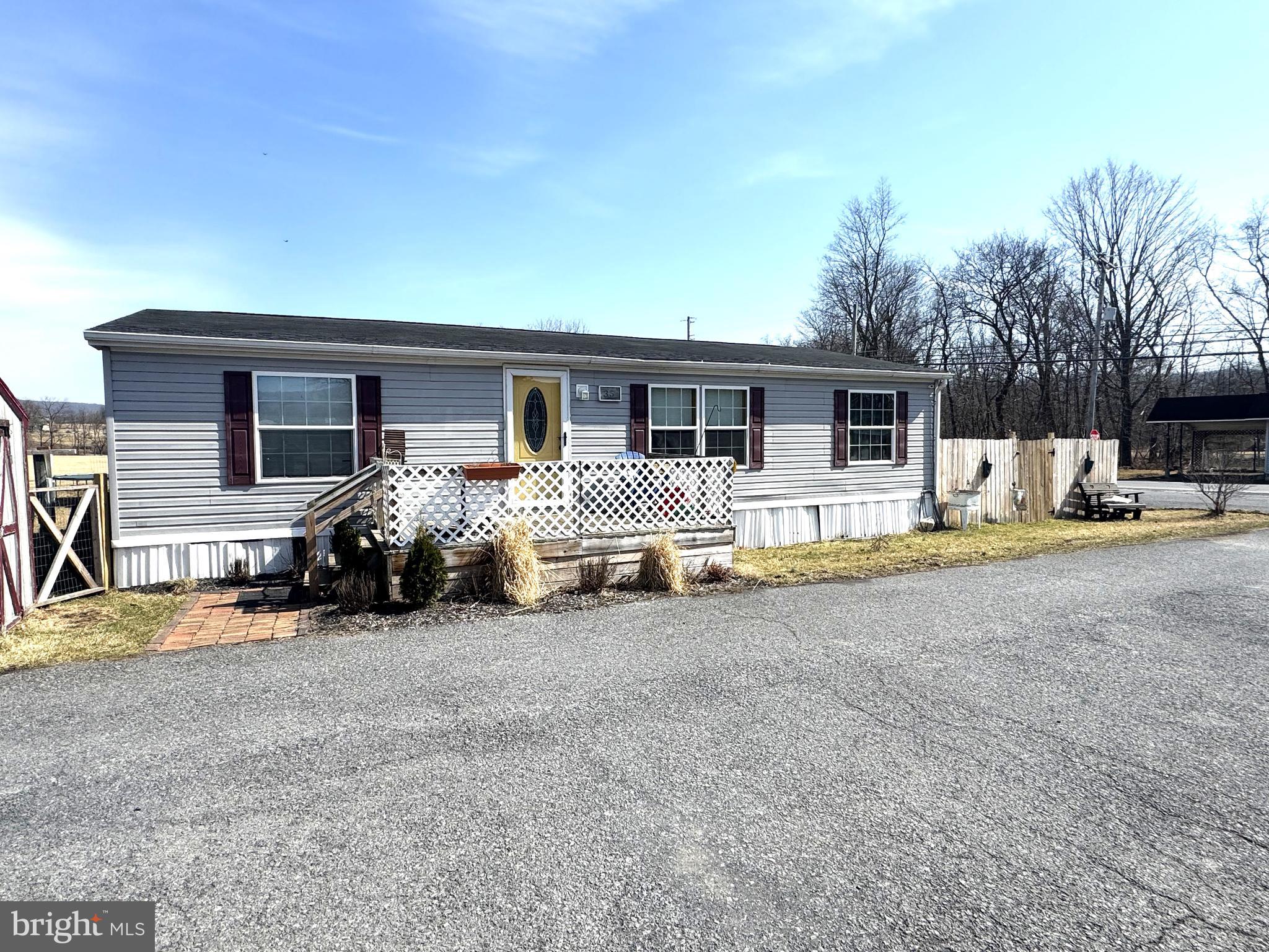 Easy living in this one floor home. This is for the sale of the manufactured home only, no real estate. Sits on a great flat lot with monthly rental of $375 to include, trash, sewer, paved parking area, maintenance of streets.  The home features a open floor plan with big kitchen & living room, a main owners suite with owners bathroom, separate laundry area, 2 additional bedrooms and a 2nd full bathroom. Included is a fenced in front yard perfect for a pool, a fenced in back yard with entrance off of laundry room. Green space with walking path that is part of Armagh township property.