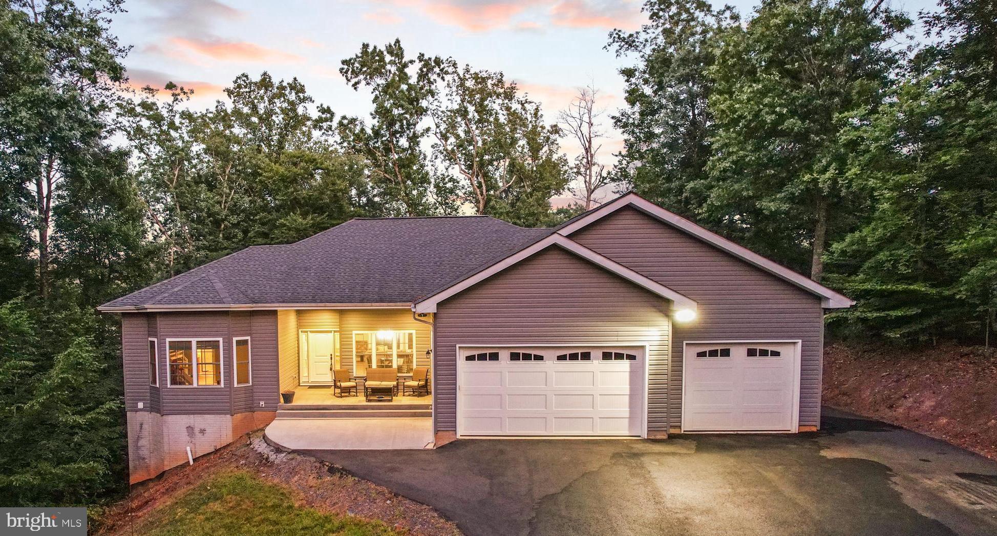 Welcome to your Happy Place at this equisite Lake Anna waterfront haven!   Experience the ultimate lakefront living in this stunning lake house, complete with its own private boathouse and dock. Nestled within a protected cove on the public side of the shores of Lake Anna, this luxurious residence spans over 4100 square feet across a sprawling 1.3 acre lot offering unparalleled views and a peaceful retreat from the hustle and bustle of daily life.  This beautifully crafted home features three spacious bedrooms spanning two meticulously finished levels, as well as several bonus/flex rooms that are perfect for guests visiting you at the lake.  The spacious interior boasts large windows that fill each room with natural light and provide breathtaking views of the lake.   The primary suite features its own oasis of an en-suite bathroom, with a stand alone tub, beautifully tiled oversize walk-in shower and double vanity. The open floor plan is perfect for entertaining and family gatherings, blending indoor and outdoor living seamlessly.  Relax on the deck with beautiful views of the lake from the sunken hot tub.  Enjoy direct access to Lake Anna with your own private boathouse and dock. Whether you're a boating enthusiast or enjoy quiet mornings fishing, this feature adds a significant touch of luxury and convenience to your waterfront lifestyle.  The expansive outdoor areas includes ample deck and patio space, ideal for hosting summer barbecues, sunbathing, or simply enjoying a quiet evening by the water. The property's location also makes it perfect for swimming, kayaking, and waterskiing.  This home comes fully equipped with modern amenities and comforts, making it an ideal turnkey solution for those looking to escape to the lake at a moment's notice. With ample storage for all your water sports equipment and more, this lake house offers both functionality and elegance.  Owning this lake house on Lake Anna isn't just a purchase; it's embracing a lifestyle of relaxation, recreation, and awe-inspiring views.   New HVAC (2024).  New LVP  CoreTec flooring (2024).  Gutter Guards/Leaf Filter for ease of maintenance. Don't miss the opportunity to make this dream a reality and create lasting memories in this exquisite lakeside sanctuary.
