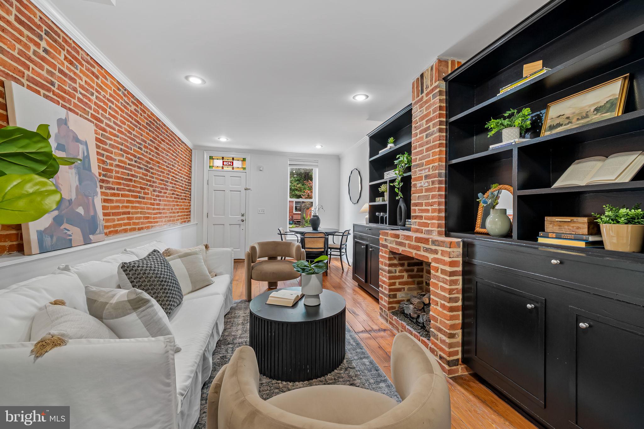 OPEN HOUSE SUNDAY, JUNE 28, 12:00 TO 2:00 PM.

Why buy a home in Federal Hill without parking? At 1438 Battery Avenue, you come home to your own private off street parking pad, eliminating one of the neighborhood's biggest frustrations. Combined with an expansive two tier rooftop deck with panoramic Baltimore skyline views, this immaculate, truly turnkey residence delivers the lifestyle today's buyers are searching for.

Lovingly maintained and thoughtfully improved by the current owner, this is a home you can purchase with confidence. The entire interior has been professionally painted, the rooftop deck has been power washed and is in excellent condition, the roof received a certification in June 2026, and both the HVAC system and hot water heater were replaced in 2024. Simply move in and enjoy.

Located on a picturesque tree lined street, this classic Federal Hill brick rowhome blends historic charm with modern convenience. Original hardwood floors, exposed brick, a gas fireplace, built in shelving, and slate kitchen floors preserve the home's character, while the first floor laundry room, powder room, and direct access to the rear parking pad make everyday living effortless. The unfinished basement provides abundant storage for bicycles, seasonal items, and outdoor gear.

The second floor features two spacious bedrooms and two full baths, including a private primary suite. The entire third floor is dedicated to a large flex space that easily serves as a home office, guest room, media room, Peloton room, fitness studio, or entertainment lounge. Unlike many Federal Hill homes, there are no spiral staircases. Traditional stairs provide comfortable access all the way to the rooftop.

The spectacular two tier rooftop deck is an extension of the home's living space, offering panoramic city views and the perfect setting for entertaining, grilling, relaxing, or watching Baltimore's fireworks.

Live just blocks from Riverside Park, the Baltimore Promenade, Cross Street Market, neighborhood restaurants, coffee shops, breweries, fitness studios, Harris Teeter, and local boutiques. Walk your dog in the park, bike along the waterfront, meet friends for brunch, or enjoy dinner just around the corner.

The location is exceptionally convenient to Interstate 95, Downtown Baltimore, the Baltimore Peninsula, Camden Station with MARC Train service to Washington, DC, Camden Yards, and M and T Bank Stadium. It is also ideal for professionals working at the University of Maryland Medical Center, University of Maryland School of Medicine, University of Maryland School of Dentistry, Johns Hopkins Hospital, Johns Hopkins University, Mercy Medical Center, and the downtown business district.

If you have been searching for an immaculate, move in ready Federal Hill townhome with private parking, a spectacular rooftop deck, flexible living space, updated mechanical systems, and timeless historic character in one of Baltimore's most walkable neighborhoods, your search ends here.