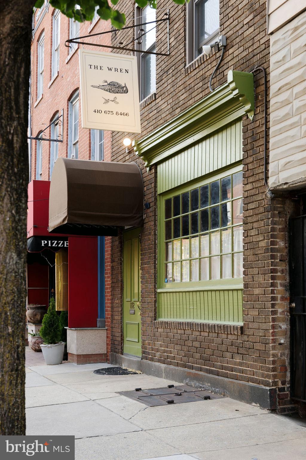 Rare opportunity to acquire The Wren,  a nationally acclaimed hospitality destination recognized by both The New York Times and Bon Appétit as one of the 20 Best New Restaurants of 2025. Located in the heart of Baltimore's historic and highly walkable Fell's Point neighborhood, this turnkey hospitality asset offers investors and owner-operators the opportunity to purchase an established business and real estate with a loyal customer base, exceptional buildout, and strong neighborhood presence.

The Wren features a thoughtfully designed interior that embraces the character of its historic surroundings while transporting guests to a traditional Irish public house with an exceptional working brick fireplace built by the former president of the bricklayers union in 1993, warm wood finishes, custom millwork, handcrafted lighting, and curated design elements create an inviting atmosphere that has become a destination for both locals and visitors. The property includes an ornate Victorian era full-service bar, commercial kitchen infrastructure, and flexible seating arrangements suitable for daily operations, private events, and special programming.

Above the commercial space, the property includes a private owner's suite spanning half of the second and all of the third floors. The residence features updated finishes, mini-split HVAC, beautiful flooring, an updated bathroom, and abundant historic charm, creating an ideal live-work opportunity in one of Baltimore's most desirable neighborhoods.

Situated along the highly trafficked Aliceanna Street corridor, the property benefits from excellent visibility, strong pedestrian activity, and a dense surrounding residential population. Its prime location provides immediate access to Baltimore's thriving dining, entertainment, and waterfront attractions.

Property Highlights
-Nationally recognized hospitality concept named among The New York Times and Bon Appétit's 20 Best New Restaurants of 2025
-Established neighborhood destination with a loyal customer base and successful Scotch Club membership program
-Turnkey operation including liquor license, furniture, fixtures, equipment, and existing infrastructure
-Historic 19th-century bar dating to approximately 1890, one of the oldest remaining bars in Fell's Point
-Owner's suite apartment occupying the second and third floors
-Prime Fell's Point location with strong foot traffic and exceptional neighborhood demographics
-Opportunity for continued hospitality operations or repositioning to an alternative restaurant, bar, or mixed-use concept
-Significant recent capital improvements including:
-Upgraded multi-zone mini-split HVAC system
-Refinished hardwood floors
-Updated walk-in cooler and draft beer system
-New wood paneling and custom-crafted sconces
-Roof replaced in 2019
-First floor fully re-joisted in 1992
-Exceptional first-floor brick fireplace constructed in 1993 by the former President of the Bricklayers Union

Offered at $1,250,000, The Wren represents a rare opportunity to acquire a nationally recognized hospitality property with a residential component in one of Baltimore's most sought-after dining and entertainment districts.