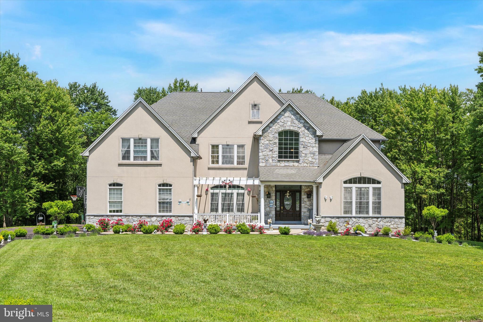 Welcome to 1035 Blacksmith Lane, a home where thoughtful updates, timeless style, and meticulous care come together in a truly special setting. Perfectly positioned on nearly two private acres at the end of a cul-de-sac, this residence offers the rare combination of serenity and convenience—just minutes from award-winning Methacton schools, major roadways, and everyday essentials.

From the moment you arrive, the curb appeal is undeniable—lush landscaping, elegant stonework, and a welcoming front porch hint at what’s to come. Inside, the grand two-story foyer sets the tone, with refinished hardwood floors that flow throughout the main living areas and a sweeping staircase accented by custom millwork.

The heart of the home is the newly renovated kitchen—designed with both function and style in mind. Featuring a large center island, quartz counters, double wall ovens, and custom cabinetry, it opens seamlessly to a sunny breakfast area and a comfortable family room with a floor-to-ceiling stone fireplace. Whether you're hosting a crowd or enjoying a quiet evening at home, the layout offers the perfect balance of open flow and defined spaces.

A dedicated home office, elegant formal rooms, and a spacious mudroom/laundry area complete the main level. Upstairs, the primary suite is a true retreat with a sitting area and a beautifully updated bath. Additional bedrooms are generously sized, with access to updated baths, including a versatile third-floor suite ideal for guests, an au pair, or multigenerational living.

The finished walk-out lower level is made for entertaining—with space for a home gym, media area, bar, and more—plus a full bath and ample storage.

Outside, enjoy a composite deck, custom paver patio, and lush, manicured grounds. With 3-zone HVAC, updated mechanicals, and quality finishes throughout, this home has been lovingly maintained and upgraded in all the right ways.

This is more than a move-in ready home—it’s one you’ll be proud to call your own.