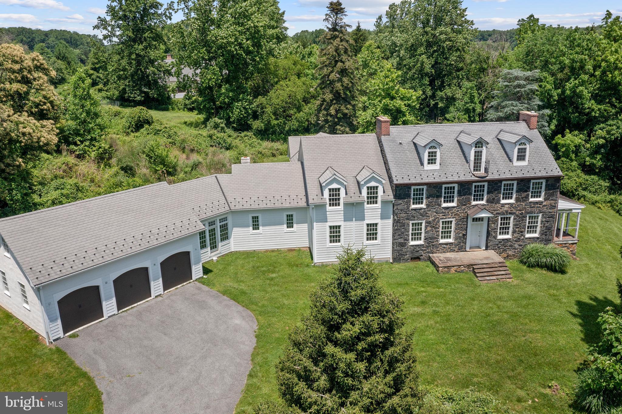 Saying 453 Bayard Rd is a historical gem of a property would be the understatement of the century! More affectionately known as the "Flower Farm"-The deed for this property can be tracked all the way back to William Penn in the 1700's-when it was a 515 acre parcel. Then granted to Joseph Pennock another famous name in KSQ-in 1701. The history is so rich with influential names, that we encourage any potential buyer to please reach out for more information with the listing agent. We have an entire binder of information from the  original developers  that we would love to share. It is believed reviewing the 1850 census the first structure on this tract of land was erected in the 1840's by Thomas Marshall Jr. for his bride- a widow Elizabeth Plankinton Sinclair. Thomas who was a Quaker was "read out of meeting" for his transgression of marrying a widow-but love overcame and he created this beautiful historical property standing today. Built with hornblende stone from a quarry on Hillendale Rd-the exterior of this home is timeless and breathtaking. The home sits atop the hill with miraculous views, and overlooks the massive 3 story barn. It is worth noting the barn has had significant utility & structural upgrades. The barn was in the process of being finished for livable space by the current owner. The best way to describe the home would be once you walk inside you take a magical step back in time-to incredible detailed craftsmanship. Once in the "old part of house" you can enjoy 3 stories of living, 4 bedrooms, 3 full bathrooms and a half bath. The loft/4th bedroom all the way upstairs features its own full bath and has amazing views of the property. The old part of the house is over 4000 plus sq ft of living space and has history tucked around every corner. All the systems have been updated to today's standards, including new electrical panels, and a high velocity hvac. In the study, or old kitchen downstairs you can cross over into the 4000 plus sq ft new addition portion of the property. From the old house walk into the family room, and then the massive kitchen- with 20ft plus ceilings with tremendous detail like barrel rolled arches, and high end tile.  Off the Kitchen there is a walkway overlooking the soon to be courtyard- that leads back to the primary suite. Radiant heat floors in the entire primary bed and bathroom. There are also two closets,  separate washer dryer hookup, massive shower area, and a dedicated room for vanities and toilet to name just a few of the great features in the primary suite..  On the other side of the addition there is a breakfast room, utility room for washer dryer hookups, and also an option for a great guest quarters with its own staircase that could serve as a 6th bedroom also. All the way downstairs there is an absolutely MASSIVE basement with 9ft ceilings and endless possibilities.  This property truly has it all. Historically significant for sure, with new world amenities for the modern buyer, the best of both worlds. Bring your vision and contractors to finish the blank canvas kitchen and other finish work to make this proeprtry one of the top show pieces in all of Kennett Township. Many structural upgrades include outside french drain, storm water management in place, new septic that has never been used. New 50 yr shingle roof, new steel roof on the barn, Geothermal HVAC systems. Approximately 8000 sq ft of living space in the house , plus 3.11 acres and a 3 story barn with structural upgrades means the value is here. "AS IS"  and CASH sale only- and this is a project- the last 25 percent of cosmetic choices, the kitchen, and finish work needs to be completed, a perfect opportunity for someone with vision.  Tremendous upside to make this a 2 million plus property in one of the most desired townships in all of Pennsylvania!