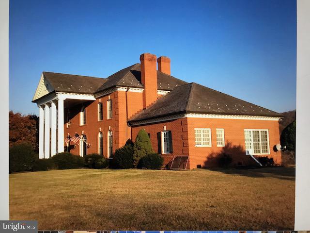 Enjoy all of the splendor and comfort in this 5000+sq ft colonial home on 21 rolling and open acres.  Desirable lakefront home with mountain views in beautiful Blandemar Farm Estates.  The brick exterior & Large entrance columns are stately.  Inside the tiled entrance foyer & curved grand staircase welcomes all entering.  Other features include recessed lighting, crown & chair molding, arched doorways, first floor grand bedroom, walk in closets, spa tubs, wet bar, interior columns, island kitchen, four wood burning fireplaces, large partially finished basement, 3 car attached basement garage and full house propane Generator.  Large french doors and designer style large windows give grand views of the lake and mountains.