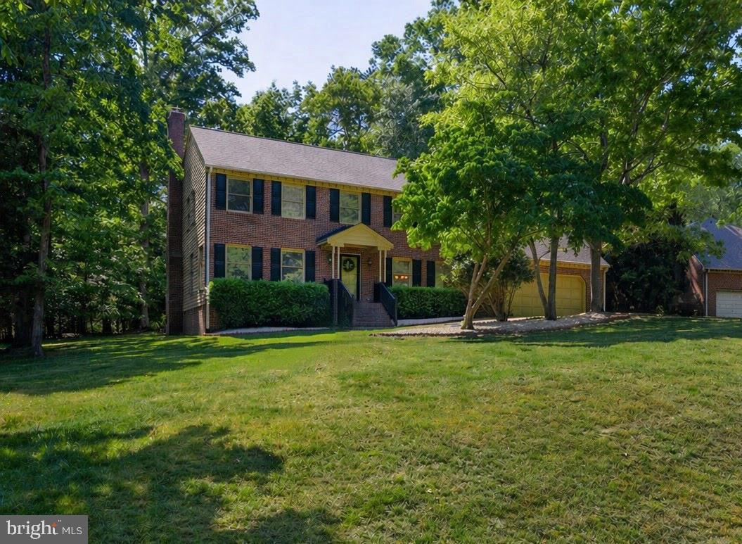 *PRICE REDUCED!* Nestled on a 3/4 acre lot, this exquisite Colonial-style residence exudes timeless elegance and charm. Step inside to discover a warm and inviting open layout, highlighted by a cozy wood-burning fireplace that serves as the heart of the living space, perfect for intimate gatherings or quiet evenings at home. The attached front-entry two-car garage provides easy access and ample storage. Surrounded by lush greenery, the expansive outdoor space invites you to unwind and enjoy nature's beauty. Whether you envision hosting summer barbecues on the rear deck or simply savoring a peaceful moment in your private retreat, this property offers endless possibilities. Easy access to I-5 & I-199 and just 15 minutes from Busch Gardens. This residence is not just a home; it's a lifestyle, where luxury meets comfort in a setting that feels both exclusive and welcoming.