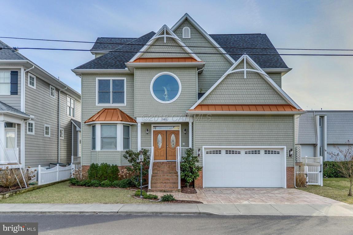 This stunning 3 story, South facing, DIRECT Bayfront home, custom built in 2009, in the quiet Caine Keys II community, provides not only gorgeous Sunrises and Sunsets, but also 3777 square feet of space for a large family or guests.  The freedom and convenience to keep your boat lifted behind your home ready for the days you want to go out on the bay or enjoying your POOL while soaking in the Sun on your back deck or walking 1/2 mile directly to the Beach and Ocean are just a few of the ammenities of living here.  This home is elegant, boasting high ceilings, a fireplace and an amazing 3rd Floor ''LOUNGE'' that will take your breath away.    This is a must see for anyone looking to get the