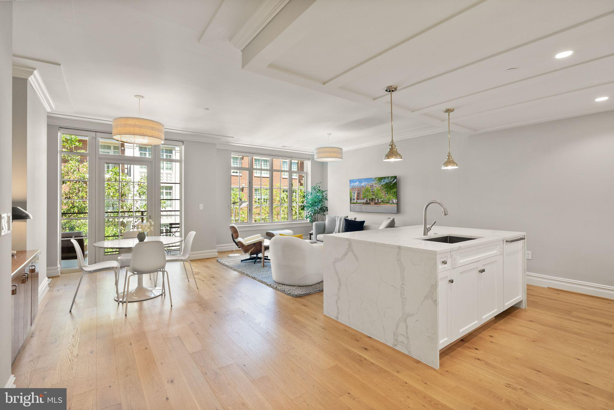 Step into a life of effortless sophistication at The Signet, McLean's premier address for luxury condominium living. Unit 415 offers a rare blend of airy, open-concept design and serene tranquility, nestled on the peaceful courtyard side of the building — a coveted position that feels worlds away from the everyday.

At the heart of this home is a chef's kitchen that truly delivers. Anchored by a granite island with seating for three, it features top-of-the-line appliances and a dedicated dining area — ideal for hosting intimate dinner parties or savoring a quiet morning coffee. The thoughtfully designed floor plan includes a generous primary suite featuring a custom wall unit with integrated media space and abundant storage, plus a walk-in closet — and a versatile den complete with a Murphy bed and dedicated home office space, seamlessly transitioning from a polished workspace by day to an elegant guest retreat by night.

Indulgence continues in the spa-inspired bathroom, appointed with a sleek dual vanity and an oversized walk-in shower with built-in seating. A dedicated laundry area with a full-sized washer, dryer, and the rare addition of a utility sink rounds out the home's exceptional functionality.

Open the floor-to-ceiling glass and step onto your private balcony to take in the fresh air and lush courtyard views below. Beyond your door, world-class amenities await — a full-service concierge, a state-of-the-art fitness center, reserved parking, and a welcoming pet-friendly community, all curated for a life of ease. Minutes from the vibrant shops and dining of downtown McLean, Unit 415 is more than a residence — it's a sanctuary at the center of it all.