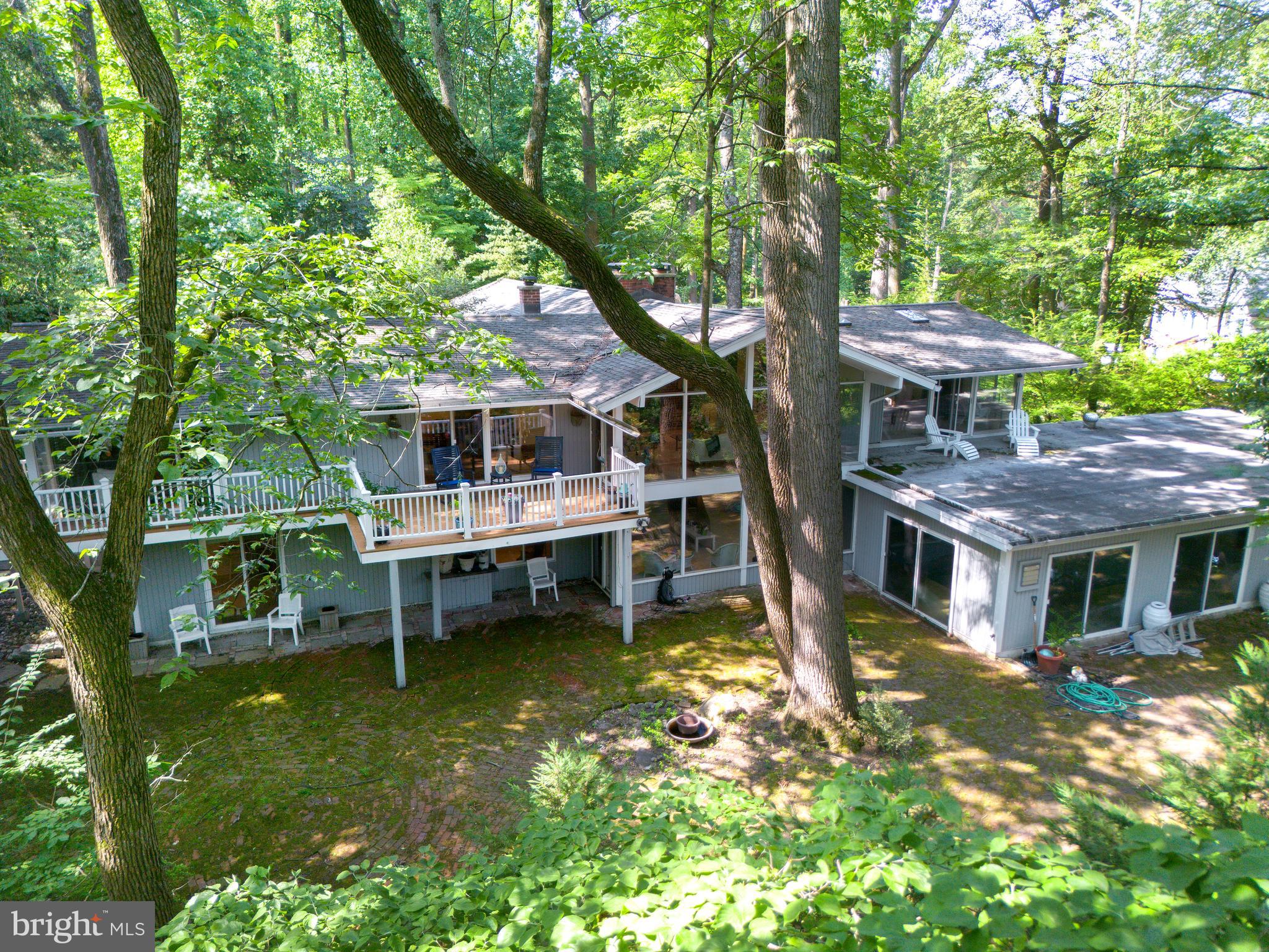 Private, Peaceful, and Perfectly Positioned- Indoor Pool Is Opened, Brick Courtyard is Ready to Entertain & New Roof just installed.

Welcome to 310 Jeffrey Lane—Rumored to be a McElroy House, this beautifully updated ranch-style home is tucked away on a serene cul-de-sac in the coveted Greene Countrie neighborhood of Newtown Square. Set on 1.23 private, wooded acres backing to protected open space, this residence offers the rare blend of modern comfort, natural beauty, and total privacy.

Inside, you're greeted by soaring vaulted ceilings, oversized windows, and hardwood floors that create a warm and airy ambiance. The open-concept living and dining areas are anchored by a striking stone fireplace and flow seamlessly onto a large deck—perfect for entertaining or enjoying your morning coffee surrounded by nature.

The thoughtfully designed layout includes a spacious primary suite tucked privately on one side of the home, complete with a walk-in closet, an updated en-suite bath, and direct deck access. Three additional bedrooms and two full baths are located on the opposite wing, offering flexibility for guests, family, or home office needs.

The walk-out lower level is a standout feature, offering an expansive family room with a second fireplace, a full in-law/guest suite with kitchenette and bath, and sliding doors that open to a peaceful brick patio and a sparkling heated pool with spa. Whether you're hosting friends or seeking quiet relaxation, this outdoor space is a true retreat.

Additional highlights include an attached two-car garage, mature landscaping, and the unbeatable benefit of backing to woods that can never be developed—ensuring privacy and tranquility for years to come.
With easy access to downtown Wayne, Newtown Square, and top-rated schools, 310 Jeffrey Lane is a rare opportunity to enjoy the best of Main Line living in a secluded and stylish setting.