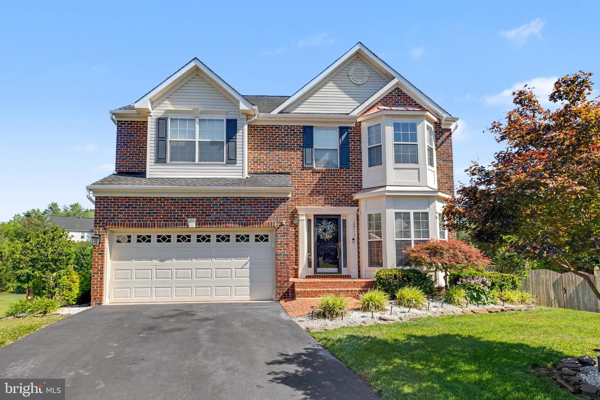 Stunning brick Colonial tucked away on a private cul-de-sac in Manassas, backing to a reserve area with private access to nearby paths. This beautiful home offers 4 bedrooms, 3.5 bathrooms, gleaming hardwood floors throughout the main level, abundant natural light, and stylish finishes. The main level features a welcoming sitting room, formal dining room, breakfast area, and an open kitchen with granite countertops, stainless steel appliances, a center island with seating, and ample cabinet space. The adjoining living room is anchored by a cozy fireplace, creating the perfect gathering space.

Upstairs, the spacious primary suite offers two closets and a luxurious en-suite bath with dual vanities, a soaking tub, and a separate stall shower. The secondary bedrooms are generously sized, and the convenience of upper-level laundry makes everyday living easier. The fully finished lower level provides exceptional flexibility with a large recreation room, den, bonus room, and full bathroom.

The outdoor living space is truly exceptional, featuring a new Trex deck with step lighting and a 50-year warranty, a large gazebo, and a beautifully designed patio with a built-in fire pit. The fully fenced rear yard offers lush green grass and a storage shed, creating a private setting for relaxation and entertaining. A two-car garage provides additional storage space, complemented by ample driveway parking.

Recent updates include a new patio exterior three-door panel with screen (2025), electrical panel (2025), Trex deck with lighting (2025), 14' x 10' gazebo (2025), cement pad with pavers under the deck (2025), asphalt driveway resurfacing and sealing (2025), dual-zone thermostat (2025), kitchen appliances including gas range, microwave, oven, and Wi-Fi-enabled refrigerator (2024), and a 50-gallon water heater (2024). Conveniently located near parks, trails, and the Prince William Parkway, offering easy access to shopping, dining, and commuter routes.