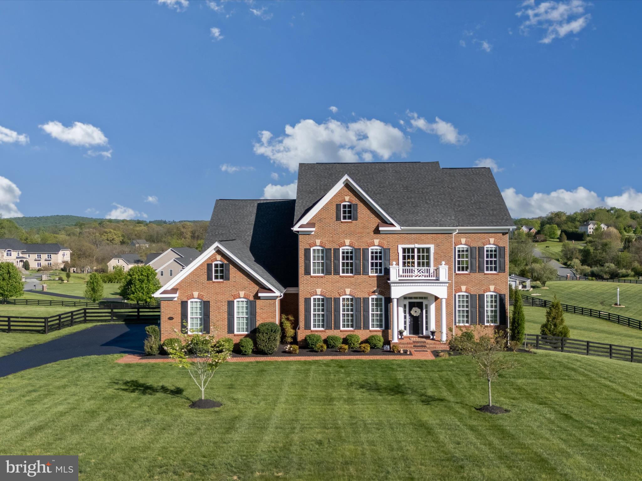 SUNDAY OPEN HOUSE CANCELLED! UNDER CONTRACT! 

Tucked at the end of a quiet cul-de-sac and gracefully sited on 3 acres of pristine landscape, this stately 2018 brick-front Colonial offers exceptional privacy, timeless elegance, and captivating sunrise views. Designed for those who appreciate quality craftsmanship and refined living, this home effortlessly combines luxury, comfort, and functionality.

From the moment you step into the inviting two-story foyer, rich hardwood floors guide you throughout the expansive main level. An elegant formal dining room sets the stage for unforgettable gatherings, while the private study is perfectly suited for work-from-home needs. The heart of the home—a glamorous chef’s kitchen—boasts granite countertops, soft-close cabinetry, stainless steel appliances including a gas range and dual wall oven, a butler’s pantry, two additional pantries, a spacious breakfast area, and access to your newly added, walk-down deck equipped with a built in grill station. Coffered ceilings continue from the kitchen and into the family room, adorned with additional  floor-to-ceiling windows that frame sweeping sunrise vistas, and a cozy fireplace that invites you to unwind in style.

Ideal for multigenerational living or long-term guests, the main level in-law suite offers both privacy and convenience. Upstairs, a luxurious primary retreat awaits, complete with a tray ceiling, sitting room, dual walk-in closets, and a spa-inspired bath featuring separate vanities, a soaking tub, and a walk-in shower. Three additional upper-level bedrooms each offer walk-in closets and beautifully upgraded en-suite baths, while a full-size laundry room ensures everyday ease and efficiency.

The lower level is a true entertainer’s dream. A custom wet bar anchors a spacious recreation area that walks out to an expansive paver patio—perfectly positioned to overlook your future pool oasis, with pool fencing already in place. A sixth bedroom, with built-ins and a dual-entry bath, offers flexible space for guests or extended family. A dedicated fitness room and ample storage room further enhance the home’s thoughtful, yet functional design.

Situated ideally off the eastern corridor of Route 9, this premier location offers a peaceful, rural lifestyle just minutes from the vibrant towns of Leesburg and Purcellville—each brimming with local shops, fine dining, and cultural experiences. Welcome to Western Loudoun, affectionately known as DC’s Wine Country, where rolling vineyards, charming farm-to-table markets, and world-class wineries define the pace of life. Enjoy easy access to Dulles International Airport, just 30 minutes away, and Washington, D.C., less than an hour’s drive—offering the perfect blend of tranquil countryside living with convenient city access.

This exceptional property is more than just a home—it’s a lifestyle. Come experience the beauty and luxury of Loudoun County living at its finest.