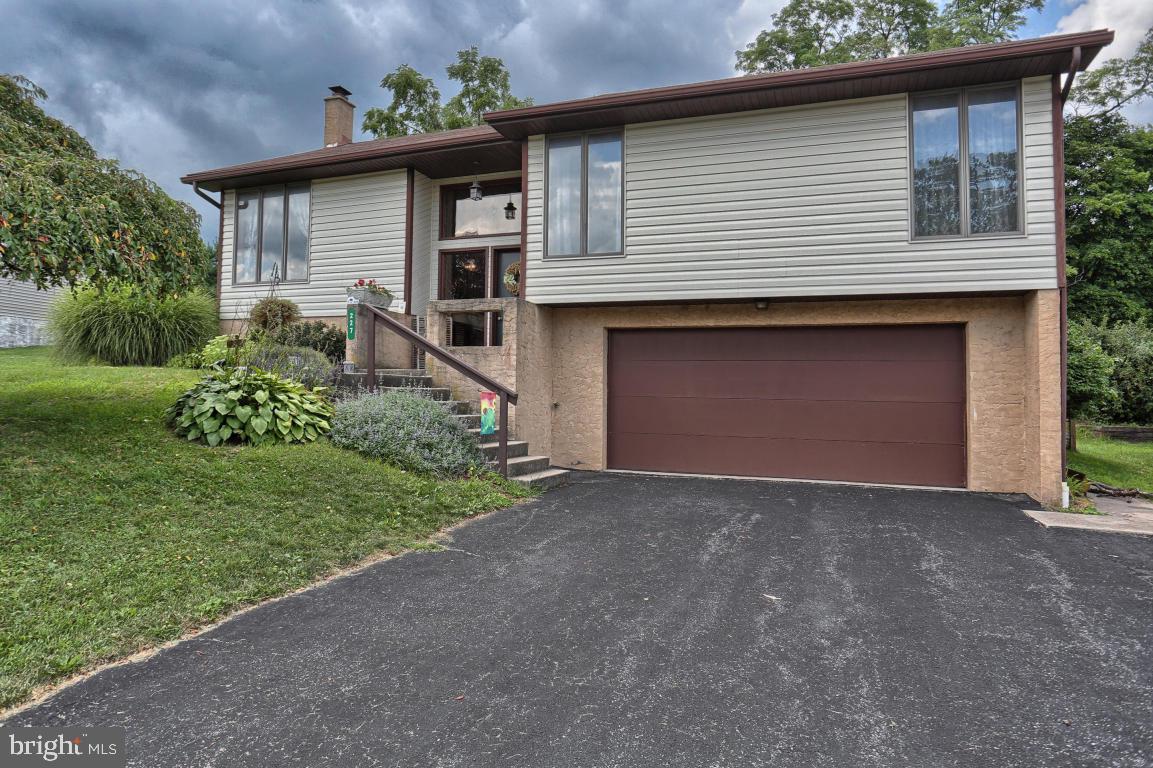 Gorgeous open concept Bi-Level home. Features include a modern, updated kitchen, hardwood flooring, and a finished daylight lower level with a cozy slate hearth/wood stove and a walk-out to a 2 car garage. Also enjoy a NEW Lennoxx central air system installed 2015 and a rear deck overlooking a large fenced-in back yard. This home is located in a very nice neighborhood on a quiet street, which is perfect for pets and children