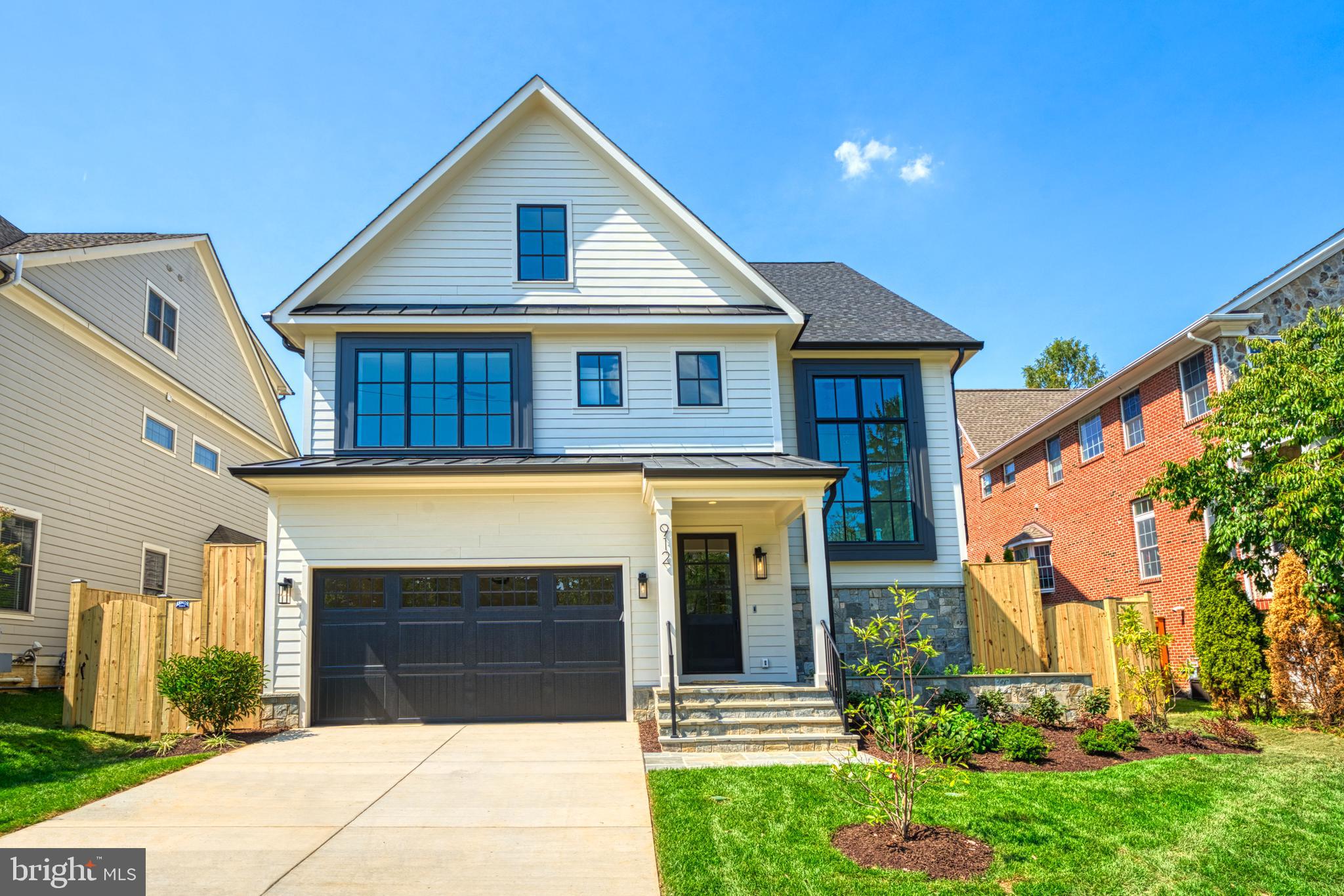 Finished and ready to move in! M-R Custom Homes presents this beautiful new custom home on a quiet street in Lyon Park, just a stone's throw to the heart of Clarendon. This home has all of the bells and whistles -  featuring 7 bedrooms, 6 full bathrooms, and one powder room with 7,085 square feet of finished living space on four levels and beautiful seven-inch white oak hardwood floors throughout the main and upper levels. The main level includes 10ft ceilings, and a beautiful gourmet kitchen with custom inset maple cabinetry, 2.5" quartz countertops, 48" Subzero refrigerator, 48" Wolf range, 2 Asko dishwashers, and a built-in Wolf microwave. The kitchen opens to spacious dining area and great room with built-ins and a gas fireplace with tile and shiplap surround. The large flagstone screened porch with heaters and speakers offers an amazing outdoor living space overlooking the backyard and includes a three-sash serving window for easy access to the kitchen. A private study, a mud room with built-ins, and an attached two-car garage with epoxy flooring complete the main level. The upper level is highlighted by a luxurious primary suite with dual walk-in closets, a spa-like bathroom with heated floors, double vanities, stand-alone soaking tub, and heavy glass enclosed shower. The 3rd floor loft is anything but an afterthought - boasting 1200 finished square feet with two bedrooms, a full bathroom, a large common area with wet bar and beverage refrigerator, and a roof deck with linear gas fireplace and incredible views. The fully finished basement includes a spacious recreation room with a full-sized wet bar with island and dual wine refrigerator columns and an ice maker, exercise room, a finished storage room, and a bedroom with full bathroom. The 7500 square foot lot is flat and includes an irrigation system, a fully fenced backyard, and a gas line for a grill. Convenient to Rocky Run Park and Zitkala-Sa Park and all things Clarendon. Under a half-mile to Clarendon Metro and easy access to Rt. 50.