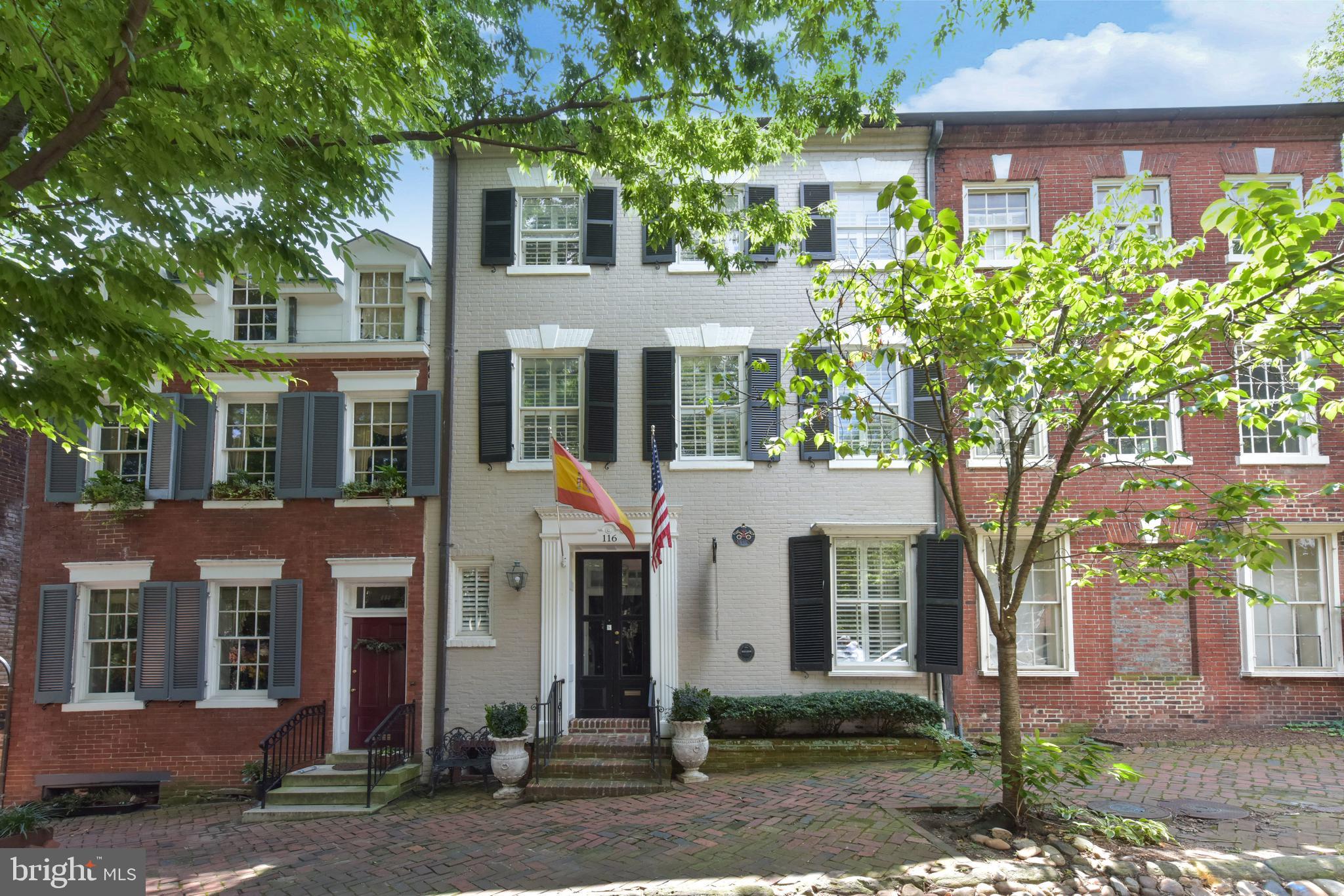Welcome to 116 Prince St (Circa 1770) This stunning Federal brick townhouse located on famed "Captains Row" in the heart of Old Town has a storied history and has recently undergone a thoughtful renovation. The recent updates maintain the historic character of the home with its original 250 year old heart pine plank flooring and moldings and builds on the European heritage with a Boffi kitchen, Porcelanosa baths and crystal chandelier lighting. There are 5 bedrooms with 3.5 baths and 3 fireplaces in over 4,300 finished SF. The kitchen opens to a welcoming family room with a woodburning fireplace and French doors leading to a charming slate patio with a tiered, walled garden featuring an outdoor living room perfect for entertaining around the gas firepit and private spa. The owners level master suite has a large living room with a fireplace and private deck overlooking the garden. The top floor has been finished to provide a huge game room with windows to Old Town rooftops and the Potomac River. The lower level has been finished with higher ceilings, a spectacular Porcelanosa bath, and a private bar complete with a wine wall and a third fireplace. Just one block from King Street, Captains Row is one of 2 historic cobblestone streets in Old Town Alexandria. Fireplaces convey as is. Shown by appointment only. This is a York Group Listing.