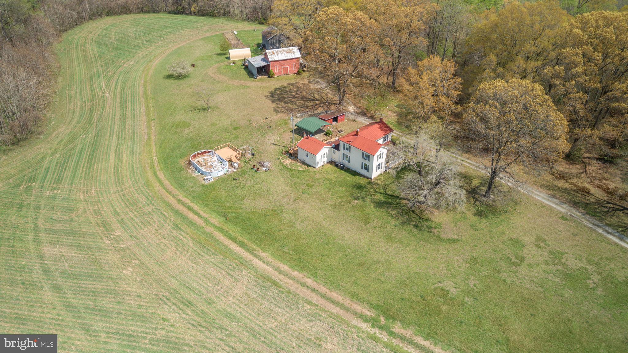 AS-IS Sale.  91 acres.  Discover the charm of this classic farmhouse style home, built in 1916, offering a perfect blend of historic character and modern convenience. With 1,522 sq. ft. of thoughtfully designed living space, this charmer features three spacious bedrooms and two full bathrooms, ideal for comfortable living. The expansive provides ample outdoor space for farming, horses, recreation, or future expansion. Enjoy the tranquility of a peaceful setting, free from the hustle and bustle. This property is not just a home; it’s a canvas for your personal touch. Located in a serene area, this home is a rare find, offering both privacy and potential. Embrace the opportunity to own a piece of history while making it your own.