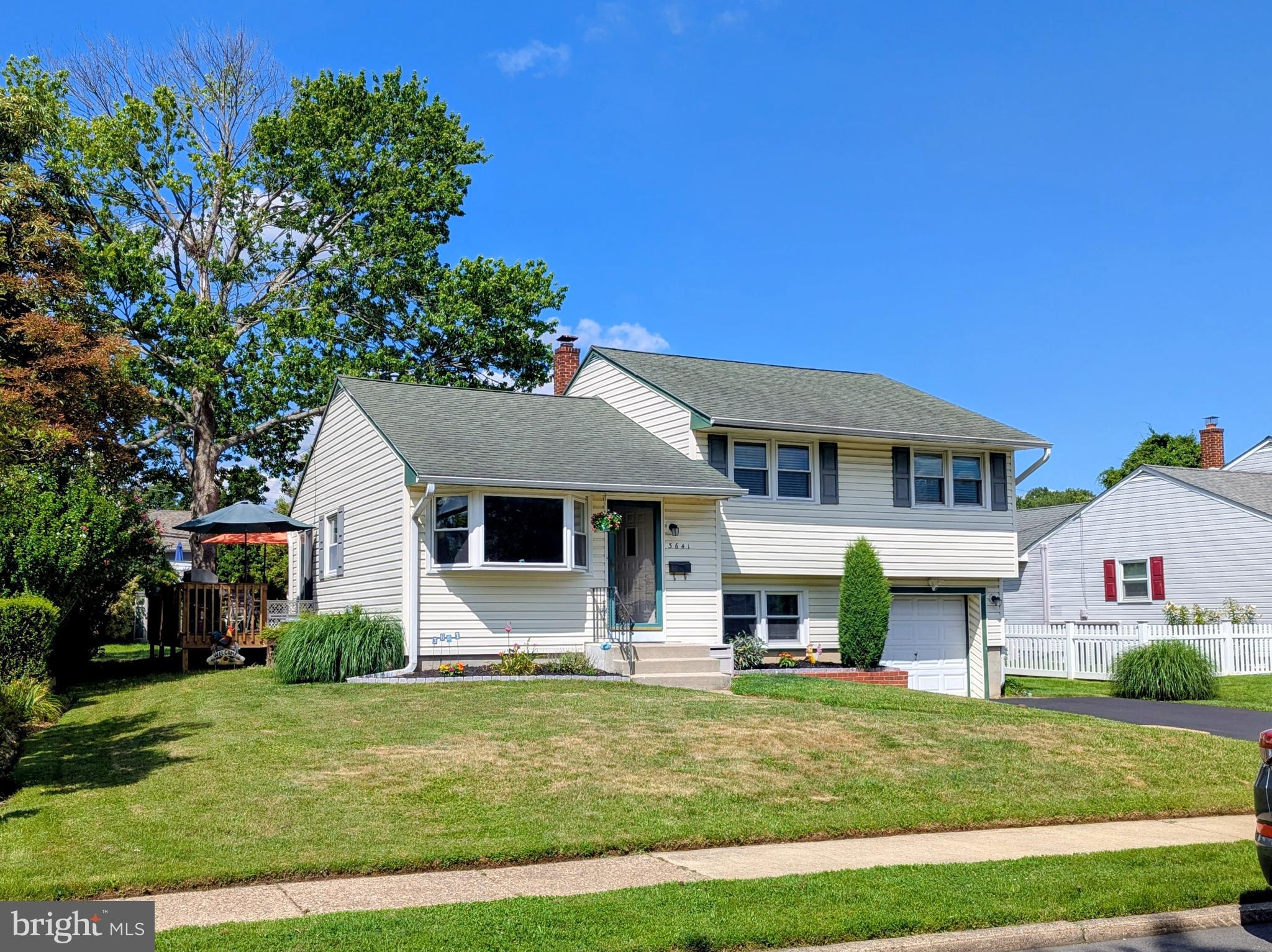 A lovely Brookhaven Borough home. This well-maintained split-level home features 3 bedrooms, 1 1/2 baths and one car attached garage with a double wide driveway. This pretty house offers comfortable living space with multiple gathering areas. The sunny and inviting living room boasts a large bay window and a gas fireplace, creating a warm and welcoming atmosphere. The eat in kitchen has ample counter tops space for food prep, a large window over the sink to enjoy the view of the rear yard and sliding glass doors leading to the large wrap around deck, perfect for outdoor dining, entertaining, or relaxing. The large rear yard with mature plantings it ready for summertime fun! The lower-level family room provides additional living and gathering space to watch sports or movies with friends. The lower level offers convenient amenities including a powder room, laundry area, rear door to the rear yard and inside access to the one car attached garage. The upper level has a full bath with a newer shower & tub 2024, and 3 nice size bedrooms. Walk up attic storage with more attic storage over the bedrooms. With its functional layout and desirable features, this home offers both comfort and convenience for everyday living. Brookhaven borough offers year-round activities through the Parks and Recreation committee. Commuter train nearby. Easy access to the Philadelphia International Airport, I-95, NJ and DE.