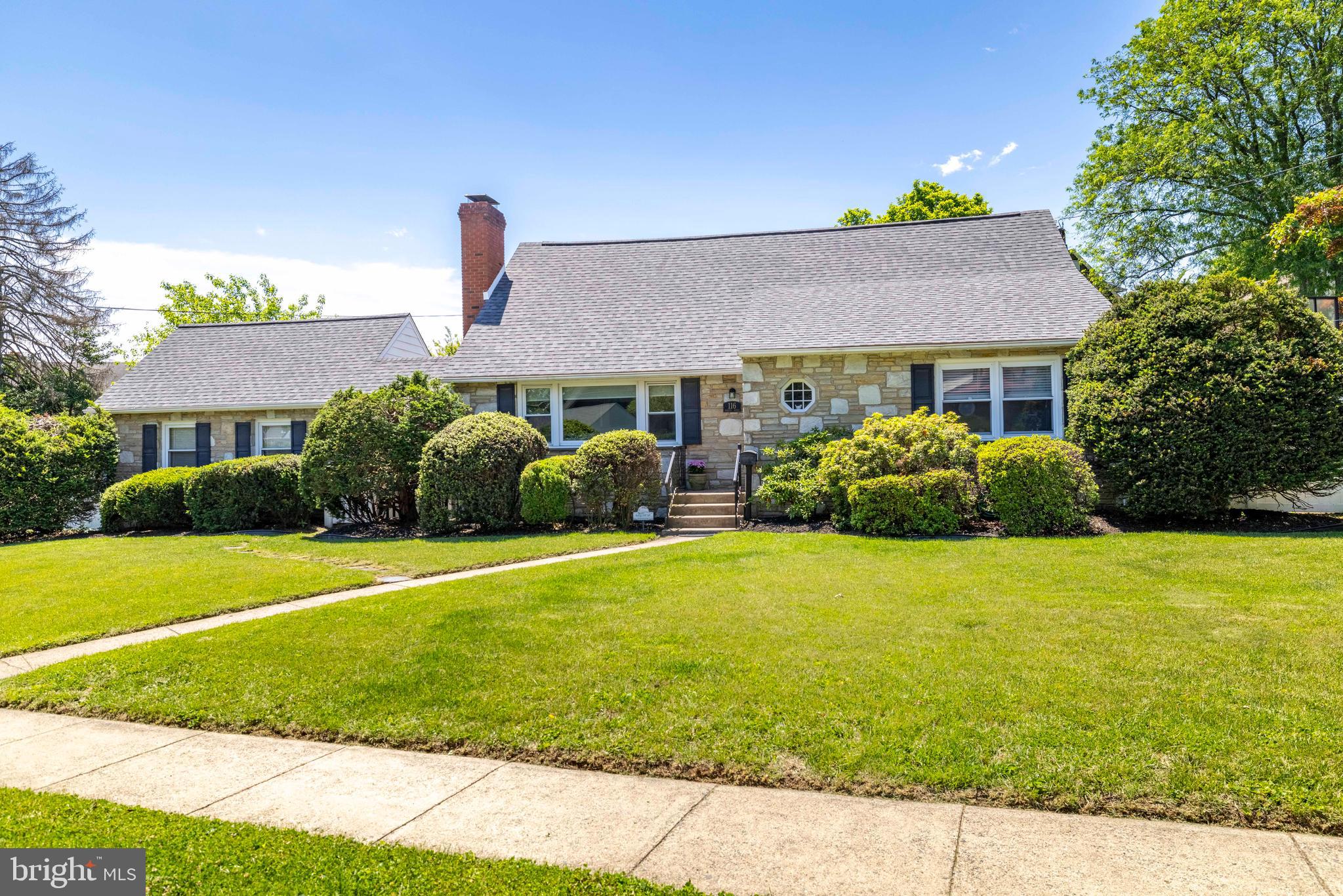 A beautiful stone-front exterior and attractive landscaping create exceptional curb appeal and set the tone for this well-maintained home. The foyer features hardwood flooring that extends throughout most of the first and second levels. The living room is filled with natural light from a large triple window that offers a fantastic view of the sunrise and is anchored by a stone, wood-burning fireplace. The formal dining room is highlighted by a chair rail and an expansive bay window that stretches nearly from floor to ceiling, bathing the space in sunlight. The kitchen offers tile flooring, a tile backsplash, stainless steel appliances, and direct access to the breezeway, patio, and garage. This gem features a versatile floor plan with two additional rooms that currently serve as an office and a first-floor primary bedroom, though both could easily be utilized as traditional bedrooms or a playroom. The room currently being used as an office overlooks the backyard and basketball area, providing an ideal workspace complete with a large storage closet. The first-floor primary bedroom features abundant natural light, a ceiling fan, and a spacious closet. A full bathroom with tile flooring, a tiled tub surround, and a separate stall shower completes the main level. The second floor offers three additional bedrooms. Two of these bedrooms are generously sized and feature oversized closets, while an additional walk-in closet is conveniently located in the hallway. The third bedroom serves as a wonderful nursery or child's room and includes ample closet space. A hall bathroom with tile flooring, a tiled shower, and a linen closet completes this level. The lower level features a fully finished, heated basement with tile flooring that hosts multiple distinct living areas. There is a dedicated recreation room equipped with a pool table, a wet bar, and shelving for toys and games, as well as a separate family room that serves as the perfect spot for game days and movie watching. An office or storage room, laundry area, a powder room, and a utility room complete the lower level, while a set of Bilco doors provides convenient access to the fenced backyard. The outdoor area is equally impressive, showcasing a beautiful stamped concrete patio with an awning, alongside a breezeway that offers the perfect setting to relax and enjoy sunrise views. Significant recent improvements provide added value and peace of mind for the next owner. A new roof was installed in 2023, followed by the installation of the HVAC system, hot water heater, and fencing in 2024. These substantial investments reflect the care and attention given to the property, allowing buyers to enjoy modern efficiency and reliability for years to come. The garage is equipped with an EV charger making it even more economical; on top of being able to walk 1 block to the train, you can charge your electric car on day 1! This property is especially well-suited for entertaining, particularly during the Fourth of July festivities, as it is located near the renowned Keswick parade route. The location is a “10 out of 10” and is within walking distance of the Glenside Train Station, Keswick Village, Roberts Block Restaurant, Elcy's Cafe, O'Neil's Market, the Keswick Theatre, Glenside Pub, and Sweet Magnolia Gift Shop. Situated in the highly regarded Abington School District and sought Copper Beech Elementary, this exceptional home seamlessly combines comfort, convenience, and a highly desirable location. Make your appointment today!