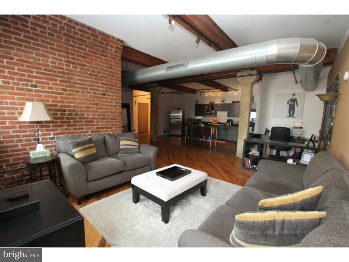 Welcome to the Loft District, one of Philadelphia's premier neighborhoods that features original 19th century factory loft conversions, much like the famed NYC Loft districts. This growing neighborhood features the walk-ability to Center City and exudes coolness with local music, art, cafe's and gastro pubs within a couple of blocks. This 1 bedroom has everything you desire in creature comforts and hip urban design. There is a large open floor plan with original refinished hardwood floors throughout. The main living area is so spacious that it can sustain a living area, dining room area and work space as well a a huge eat in size kitchen. The kitchen includes a GAS range, dishwasher, refrigerator, all stainless of course. The cabinets are modern flat panel design with granite counters. The stainless chef table comes with the unit. Enjoy beautiful exposed brick, original massive timber beams and cement columns as well as a private covered balcony. The bedroom has a fitted closet for clothing, a hall laundry room and coat closet as well as a full bath with Jack and Jill doors. Elevator building. We welcome your visit and recommend you check out Lift Cafe for coffee or a quick nibble and drink at Prohibition Tap Room.